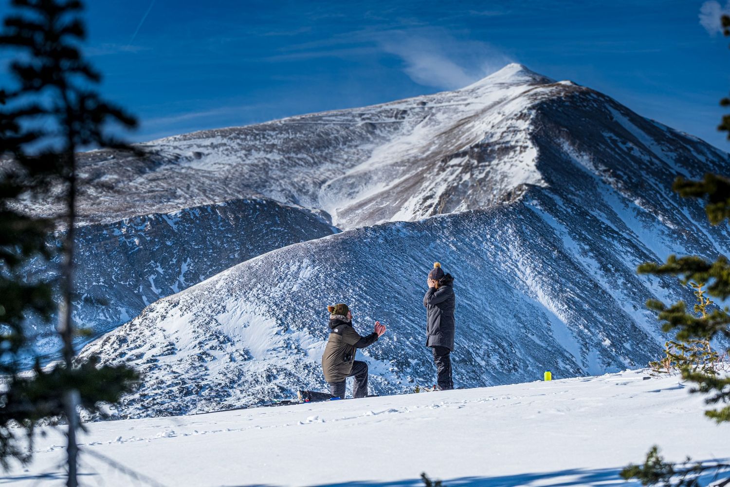 Photograph of man down on one knee near Breckenridge, CO (marriage proposal - North Star Mountain -  winter)