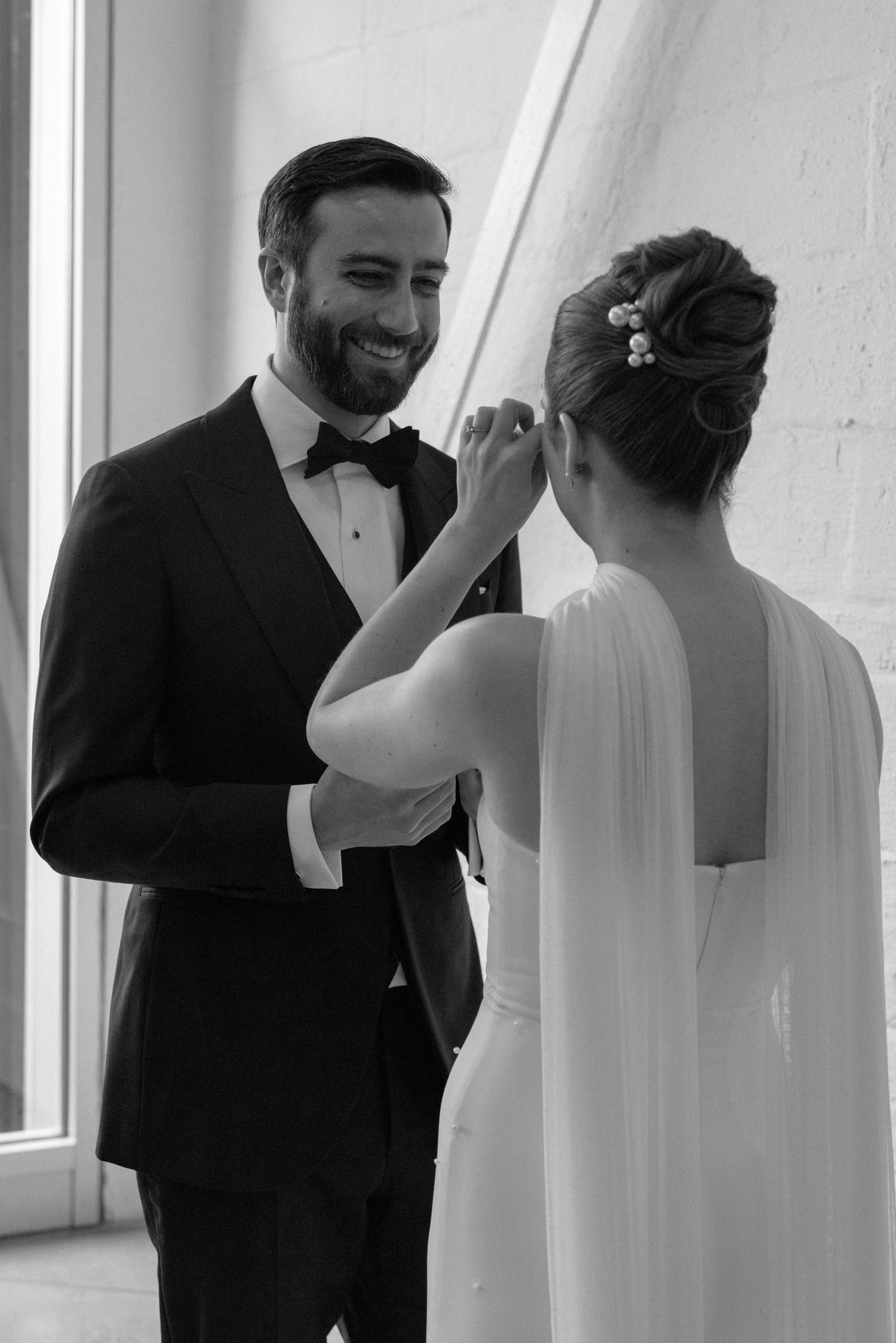 An intimate moment shared between a couple during their wedding preparations.