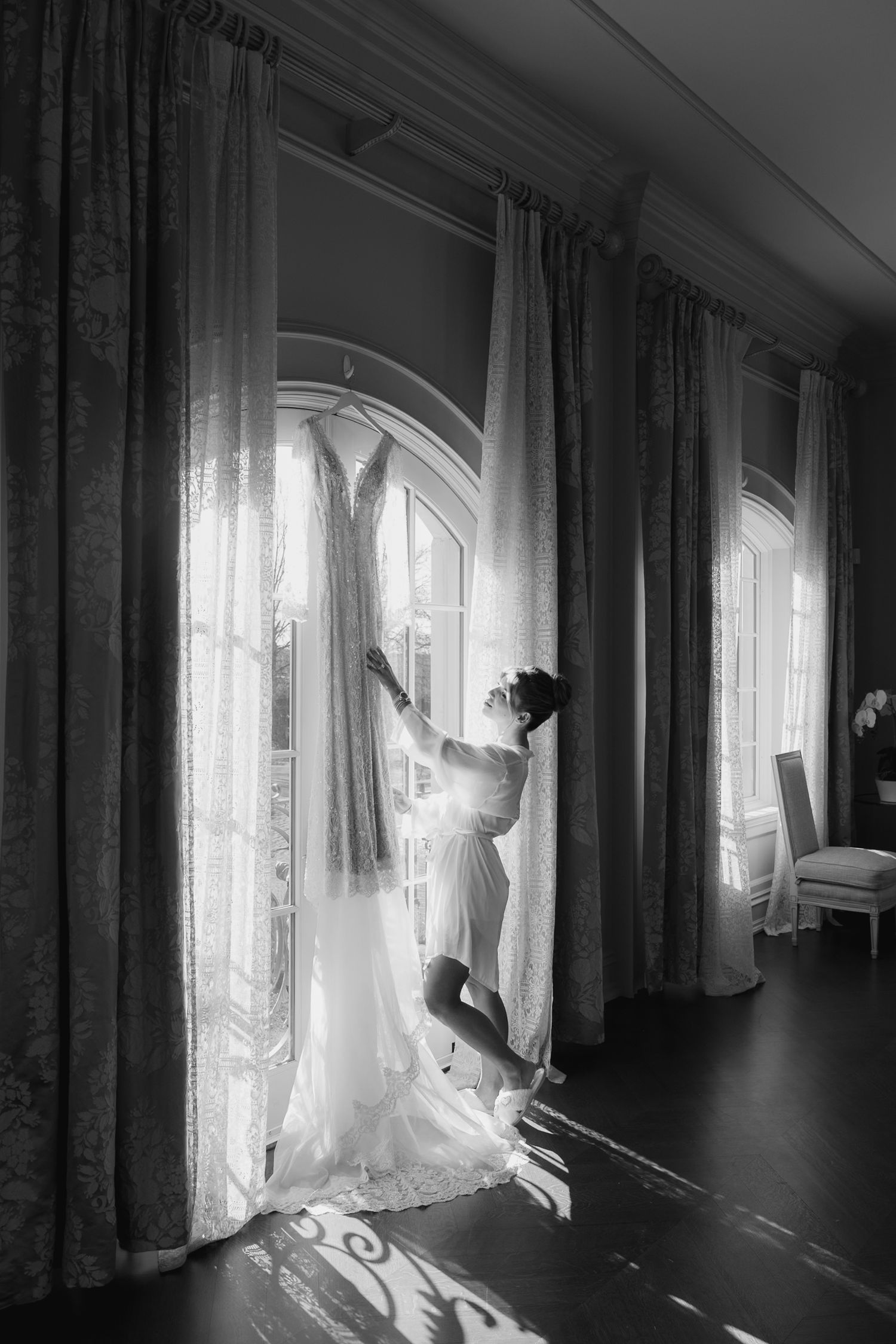 Ethereal morning light streams through sheer curtains in an elegant room creating a dreamy atmosphere.