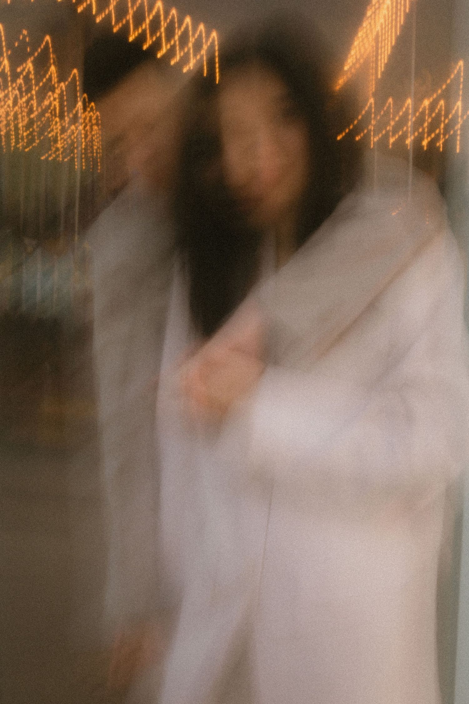 An artistic blurred photo with orange bokeh lights creating a dreamy wedding atmosphere.