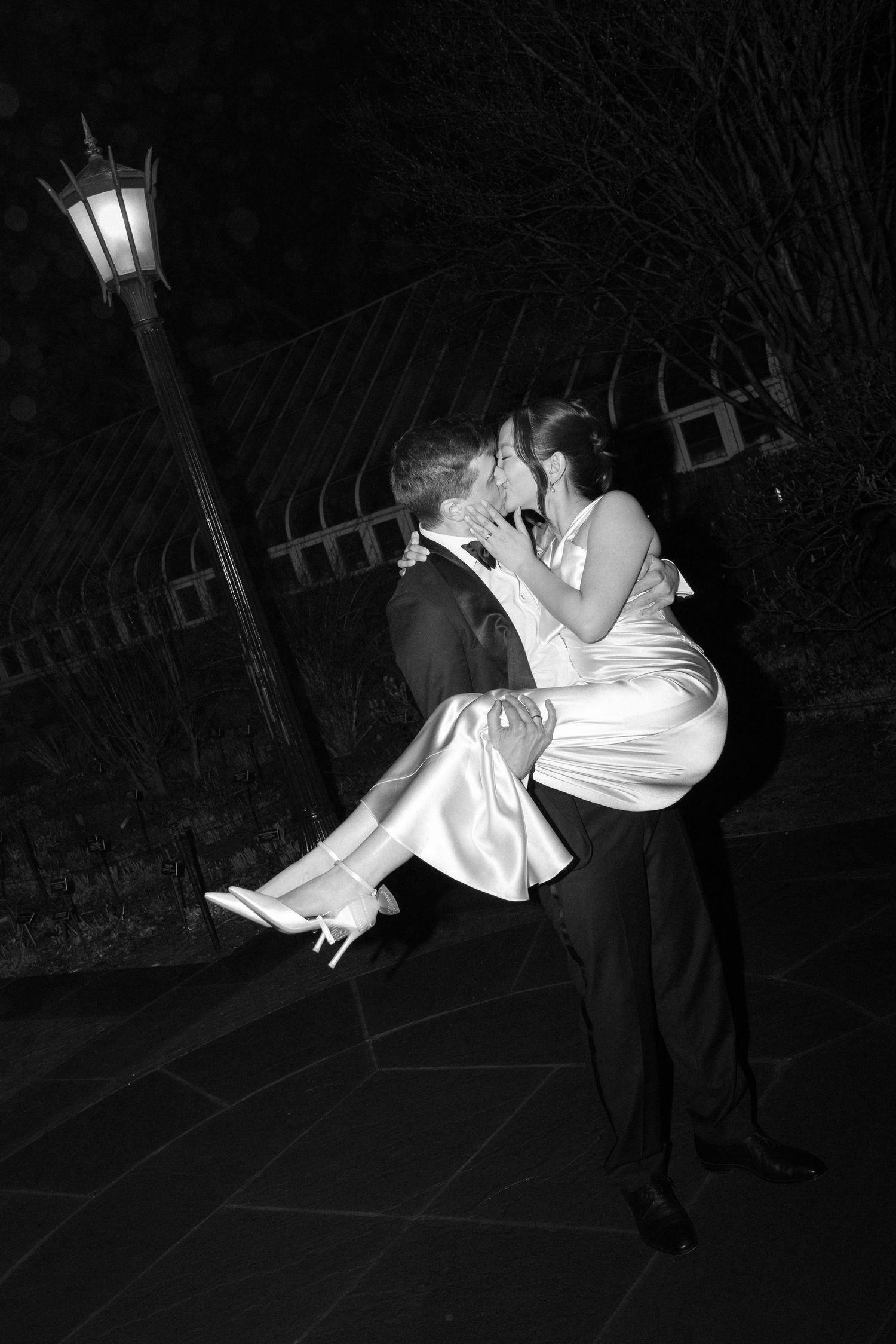 Demonstration sequence showing fine art dance movement with a lift against a dark background in black and white.