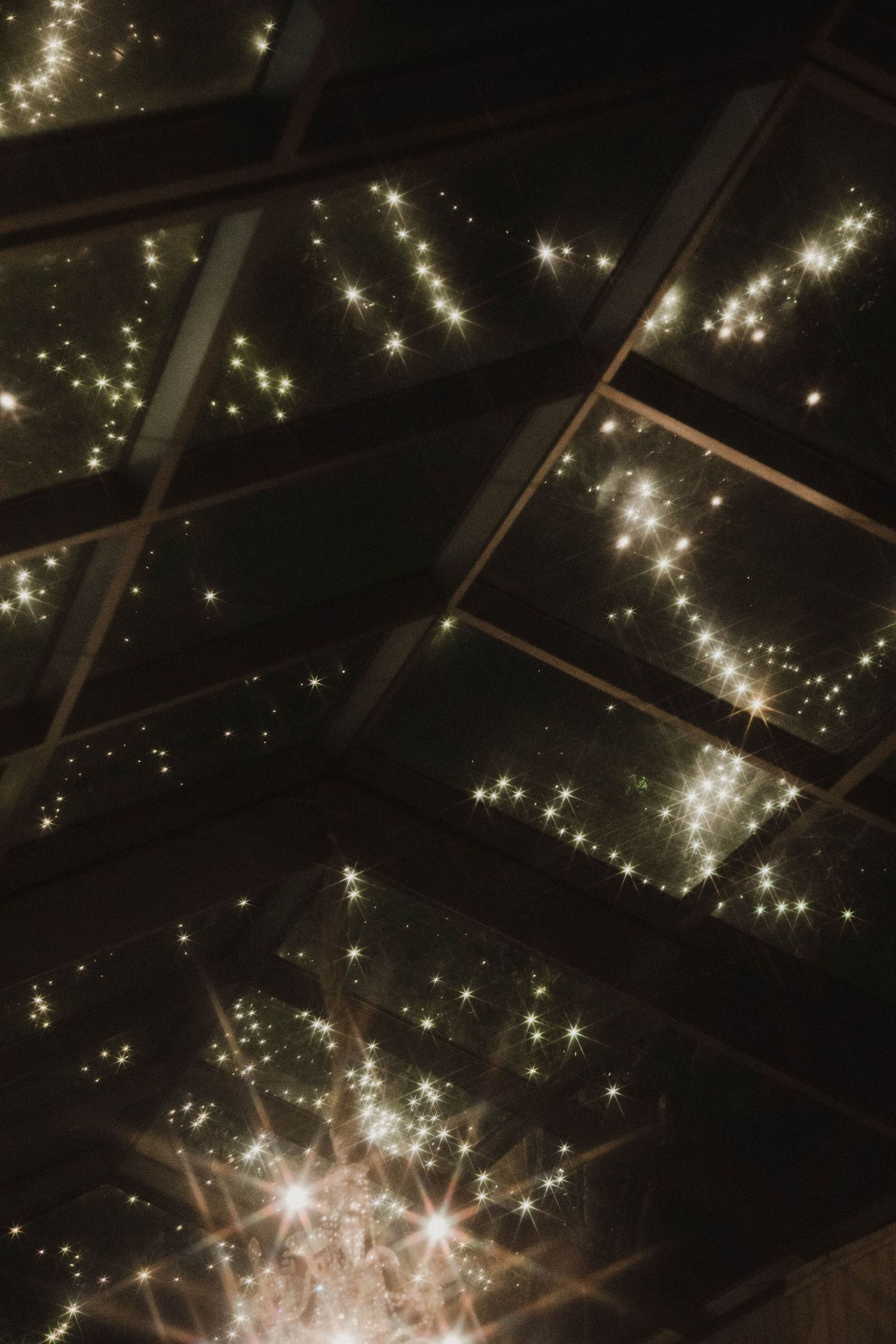 Twinkling lights and sparkles against a dark night sky.