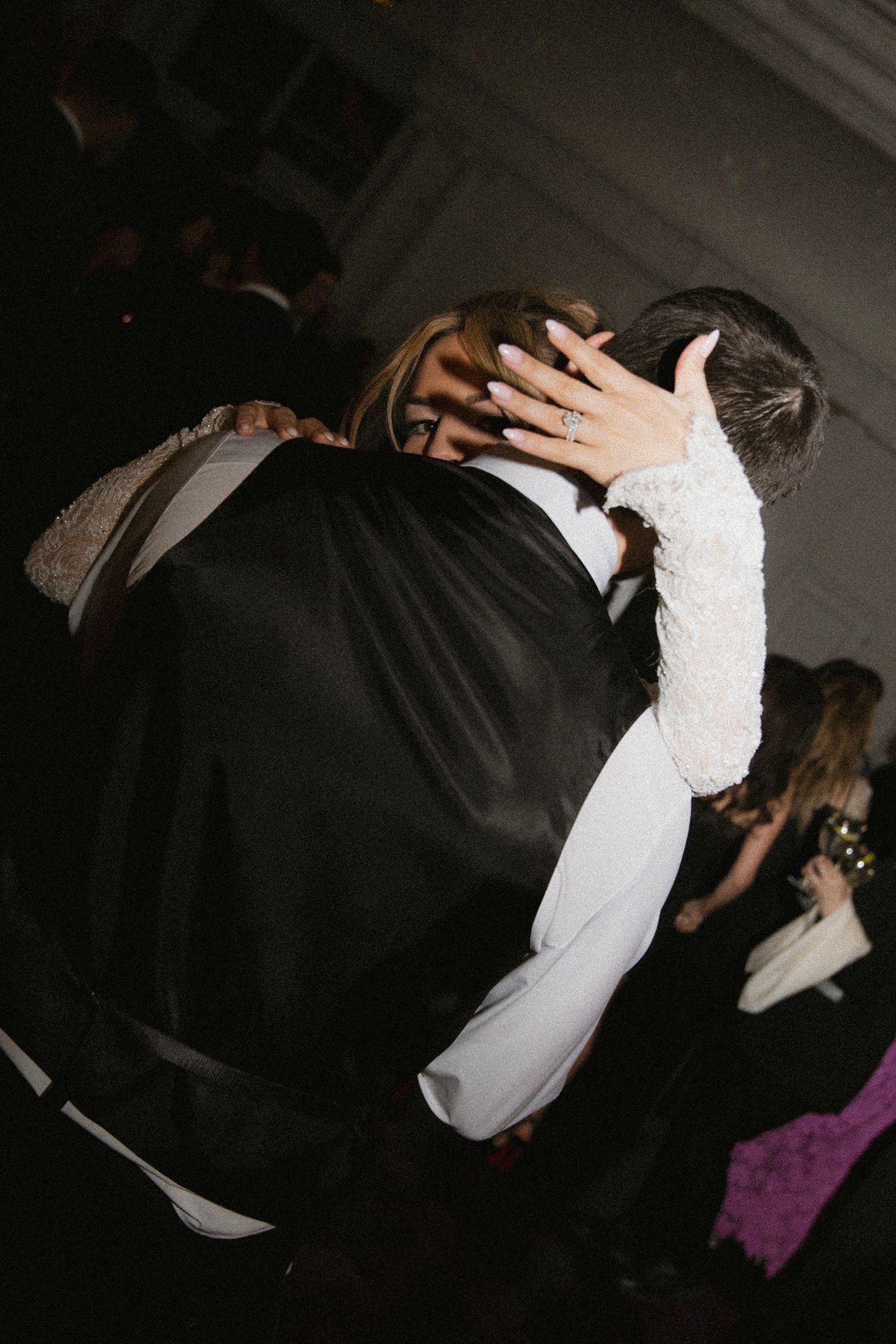 Intimate dance moments captured during a dimly lit wedding reception.