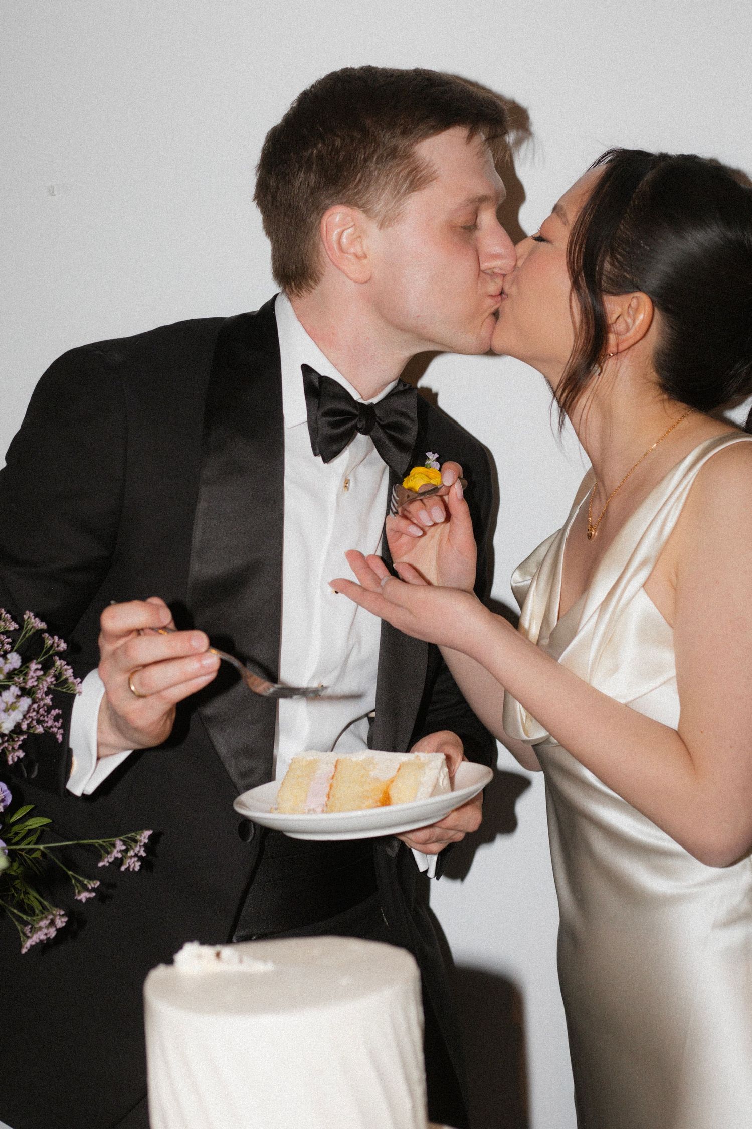 Couple shares a moment while cutting their wedding cake together.