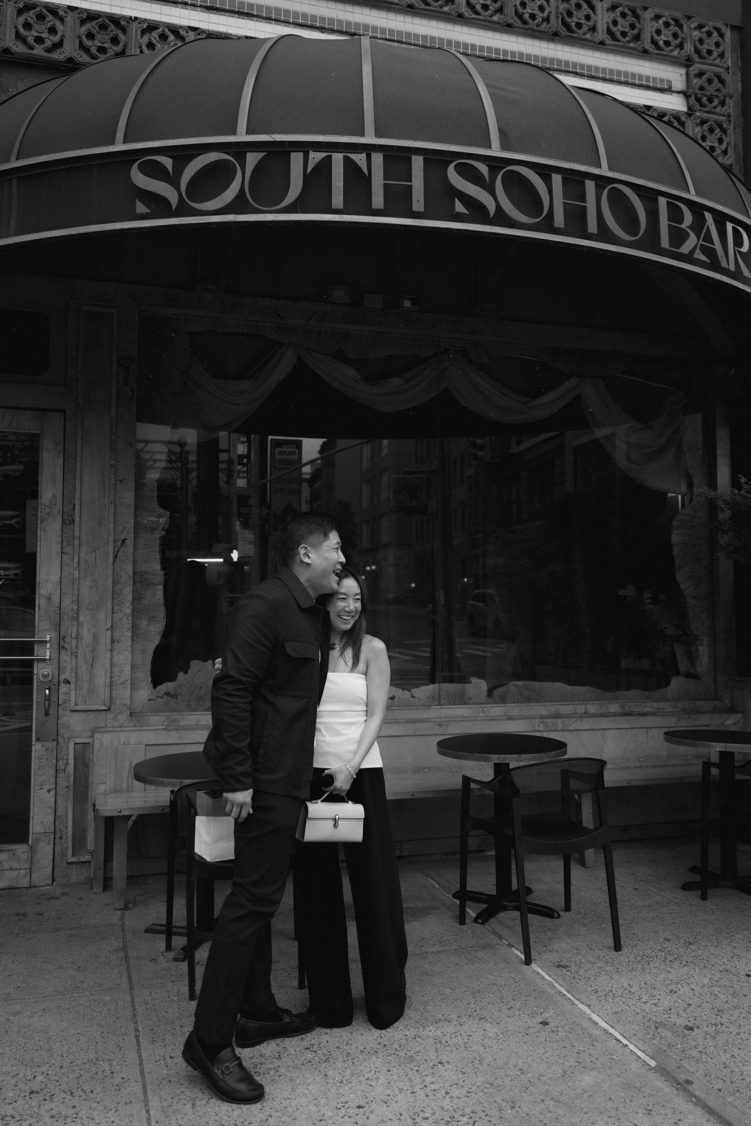 A sequence of black and white images showing two people sitting on a bench outside a storefront.