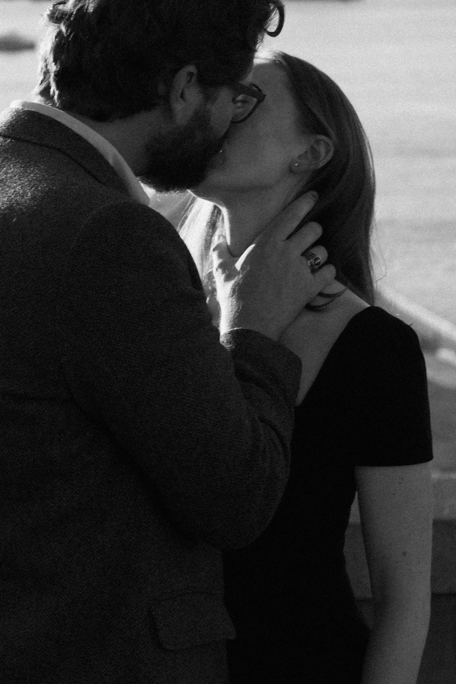 Black and white romantic sequence showing an intimate kiss between two people.