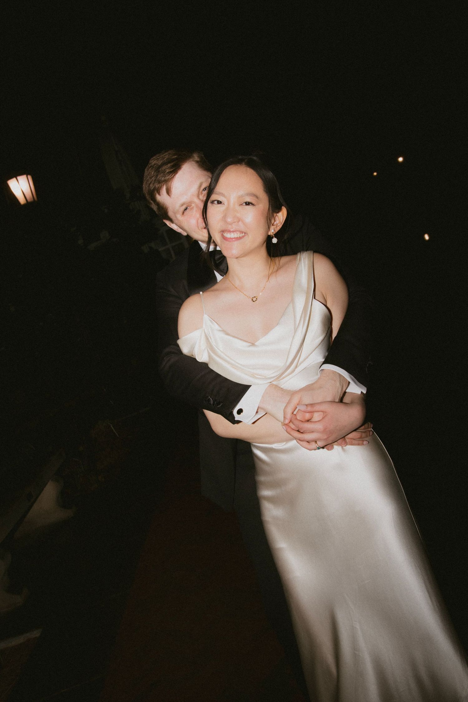 Couple sharing an intimate dance moment in elegant wedding attire.