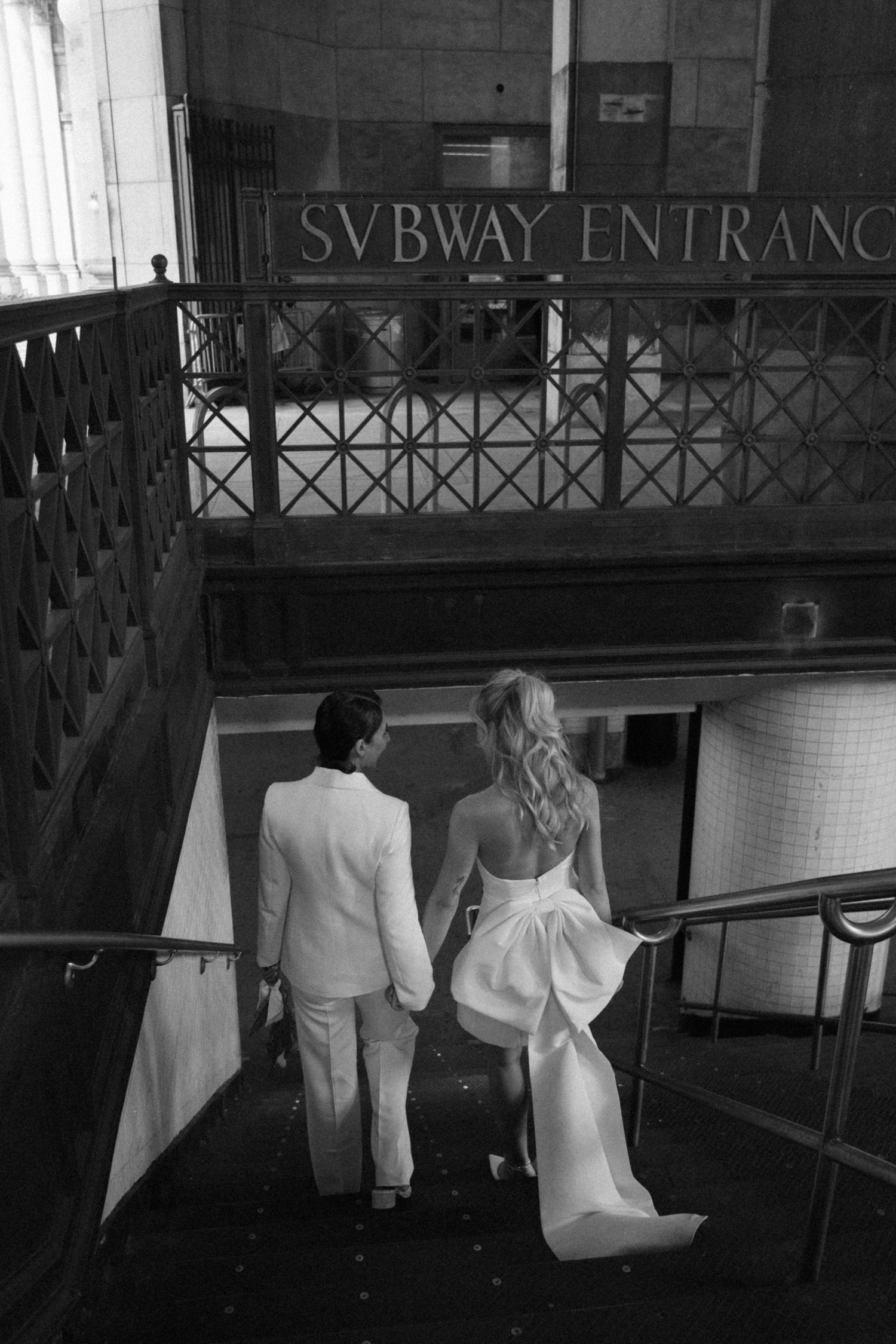 A black and white photo sequence shows two people in formal attire walking down subway station stairs.
