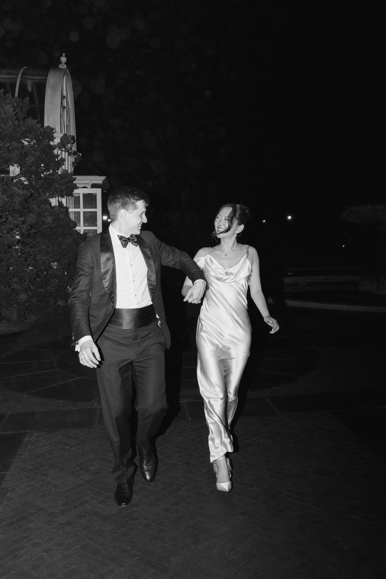 Two people walking together at night in formal attire, captured in a series of black and white photos.