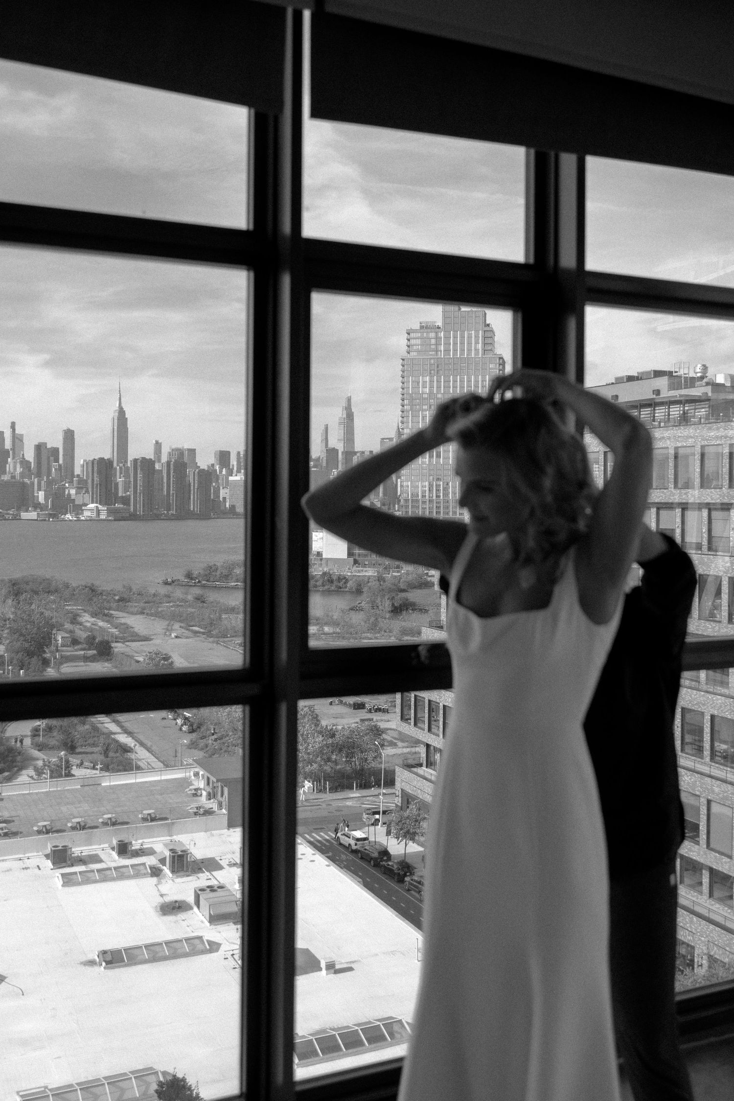 A black and white panoramic view of a city skyline seen through a series of windows.