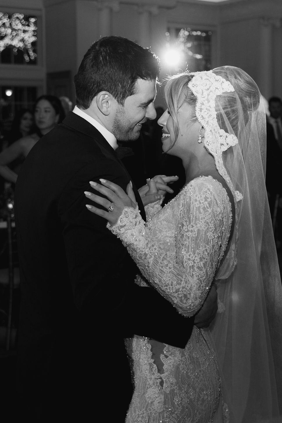 A romantic black and white photo sequence shows a bride in lace and groom sharing their first dance at a wedding reception.