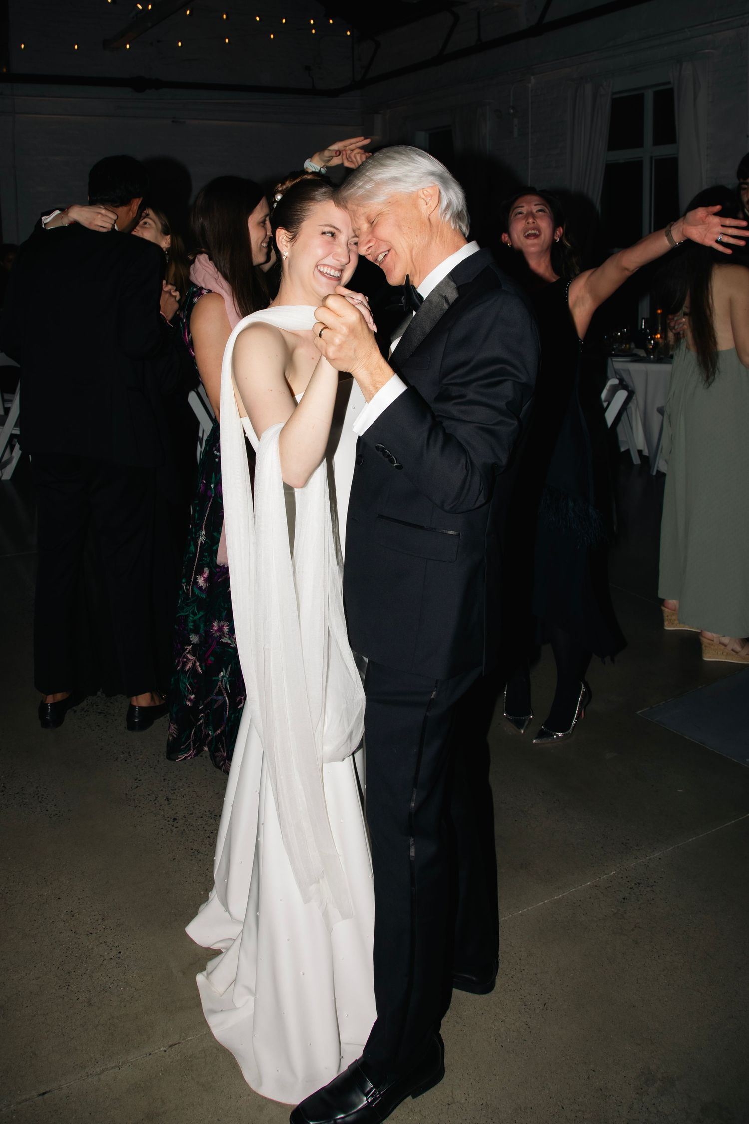 A couple shares an intimate dance moment at their wedding reception.