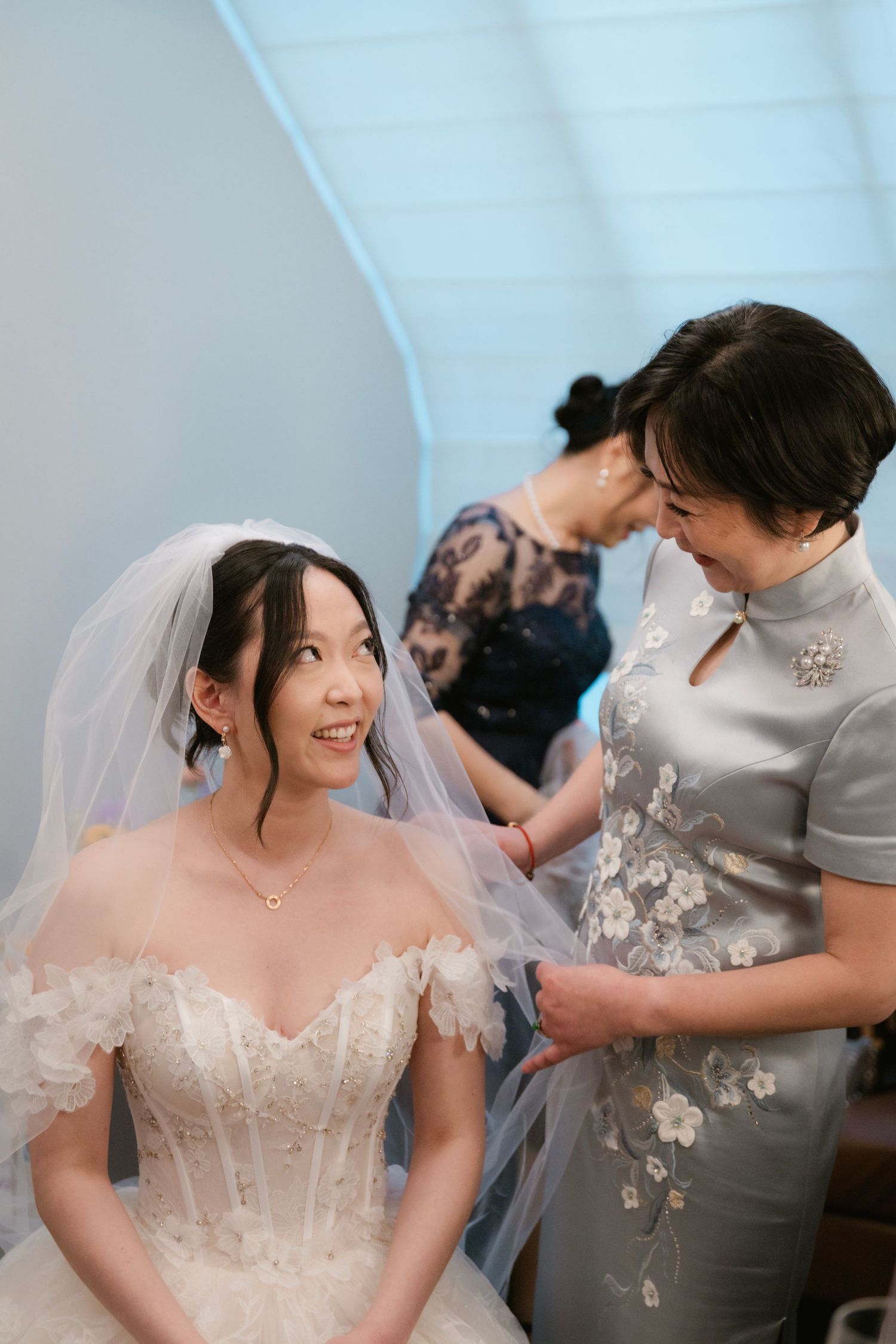 Intimate getting ready moment with traditional floral qipao dress.