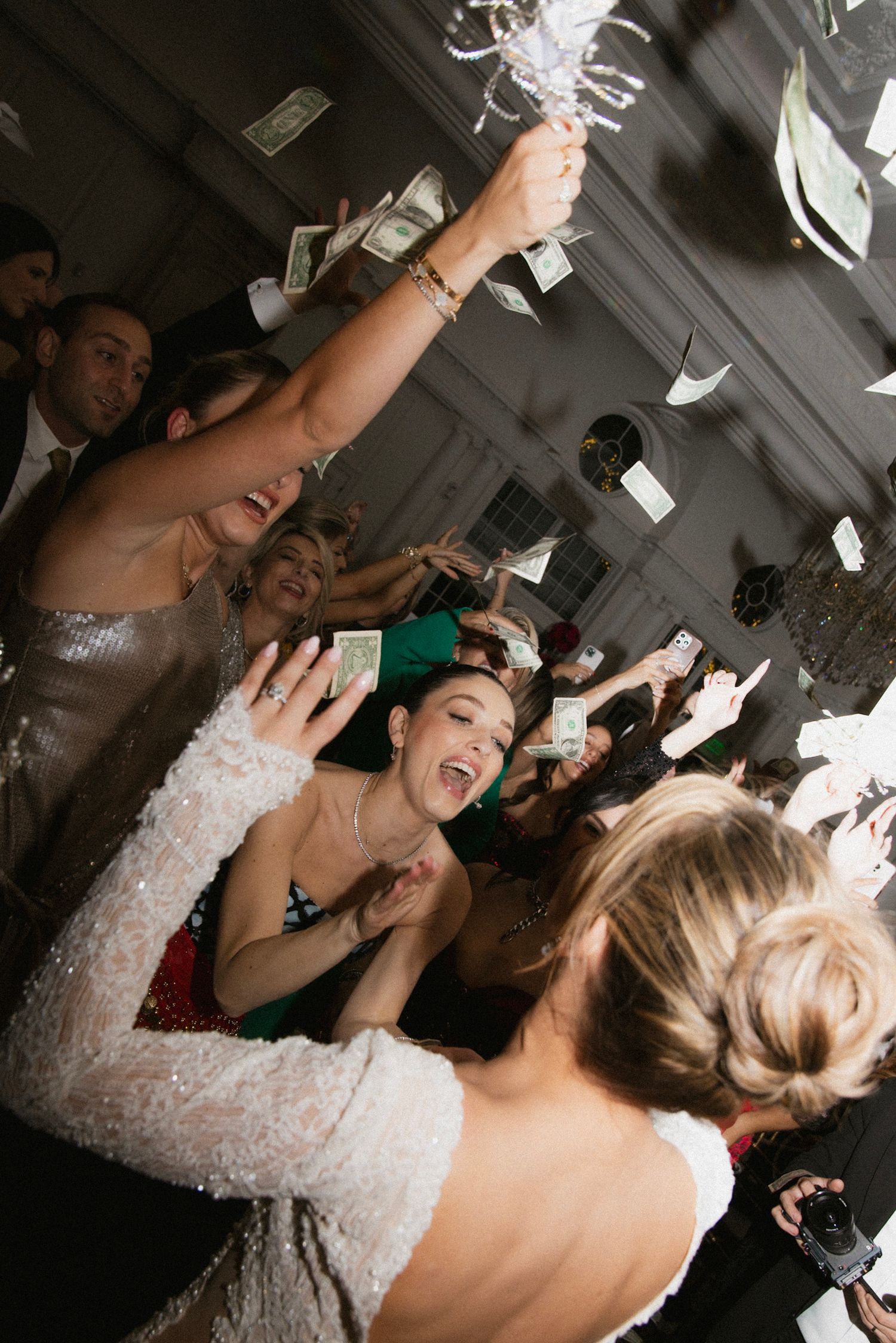 High-energy wedding reception party with guests dancing and celebrating.