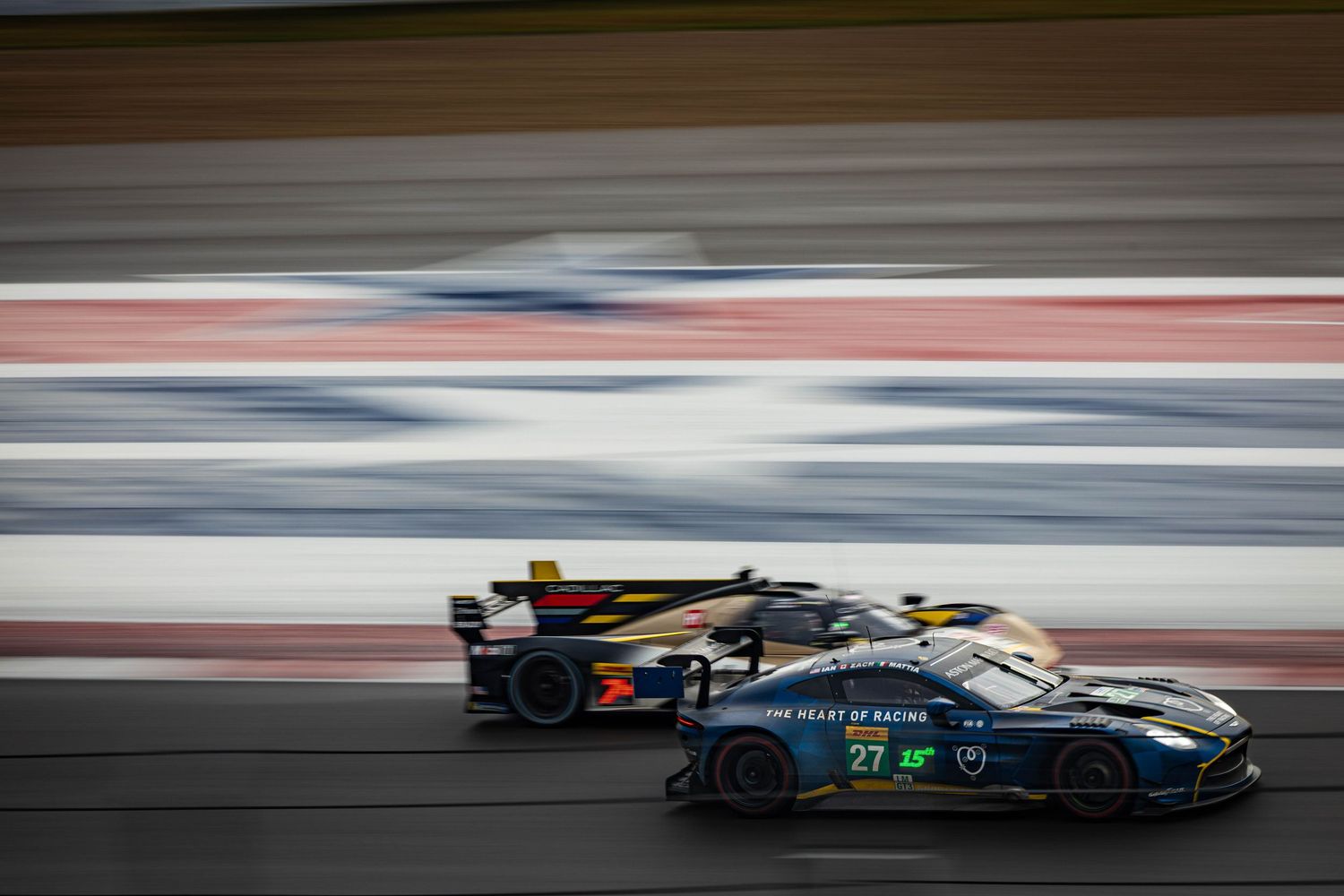 Two endurance race cars, Aston Martin GT3 and LMP2, competing side by side on track.