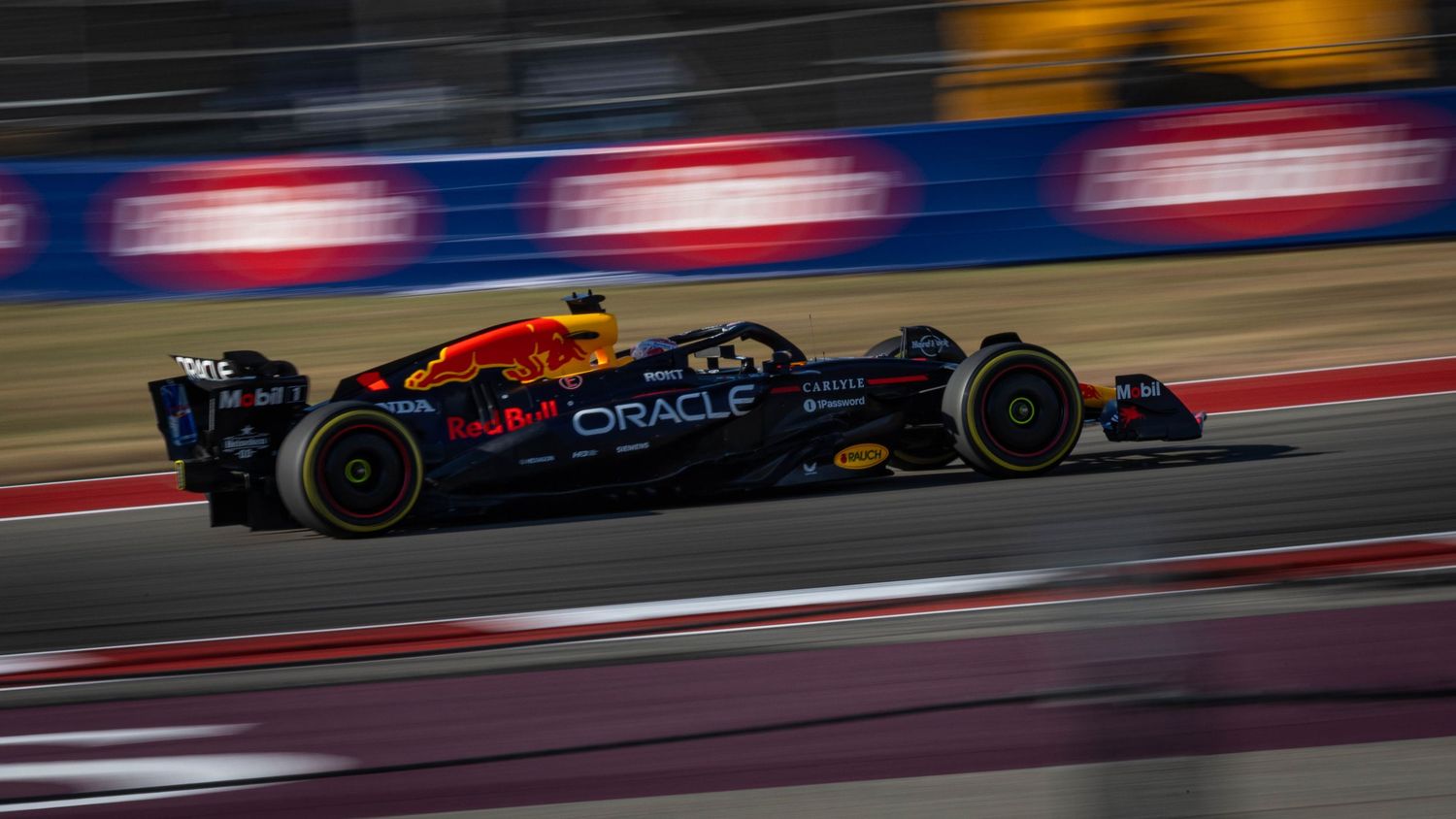 Oracle Red Bull Racing Formula 1 car speeds through Circuit of the Americas during a race event.