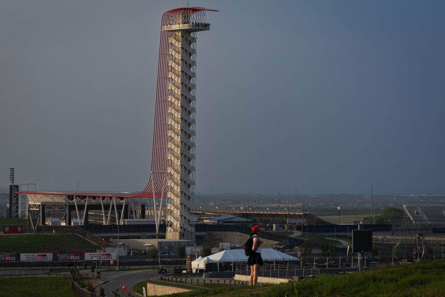 Iconic Circuit of the Americas observation tower standing tall against a dramatic stormy sky in Austin, Texas.