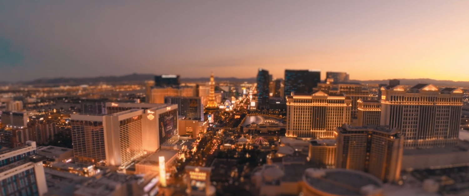 Panoramic aerial view of Las Vegas Strip skyline at dusk with city lights.