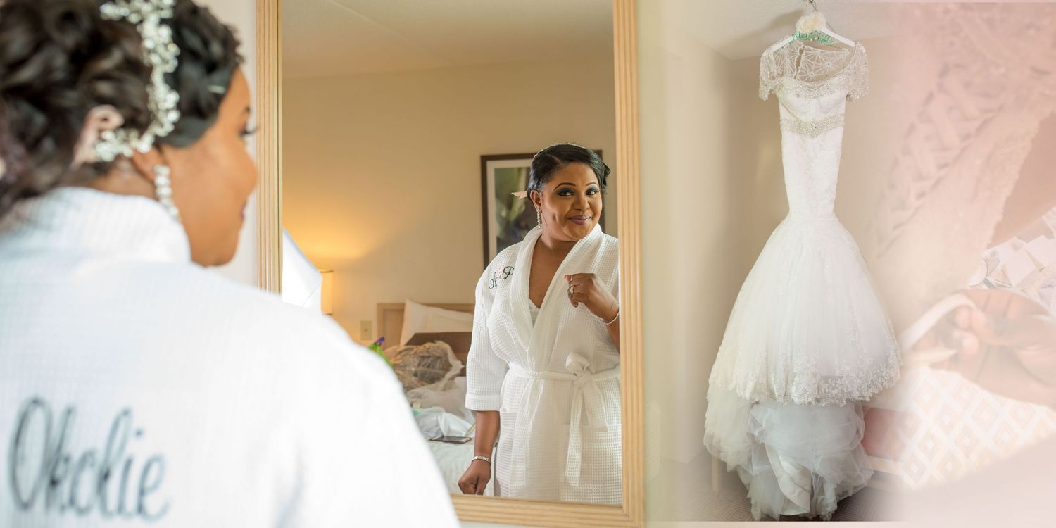 Bride seeing herself in mirror for the first time in wedding dress