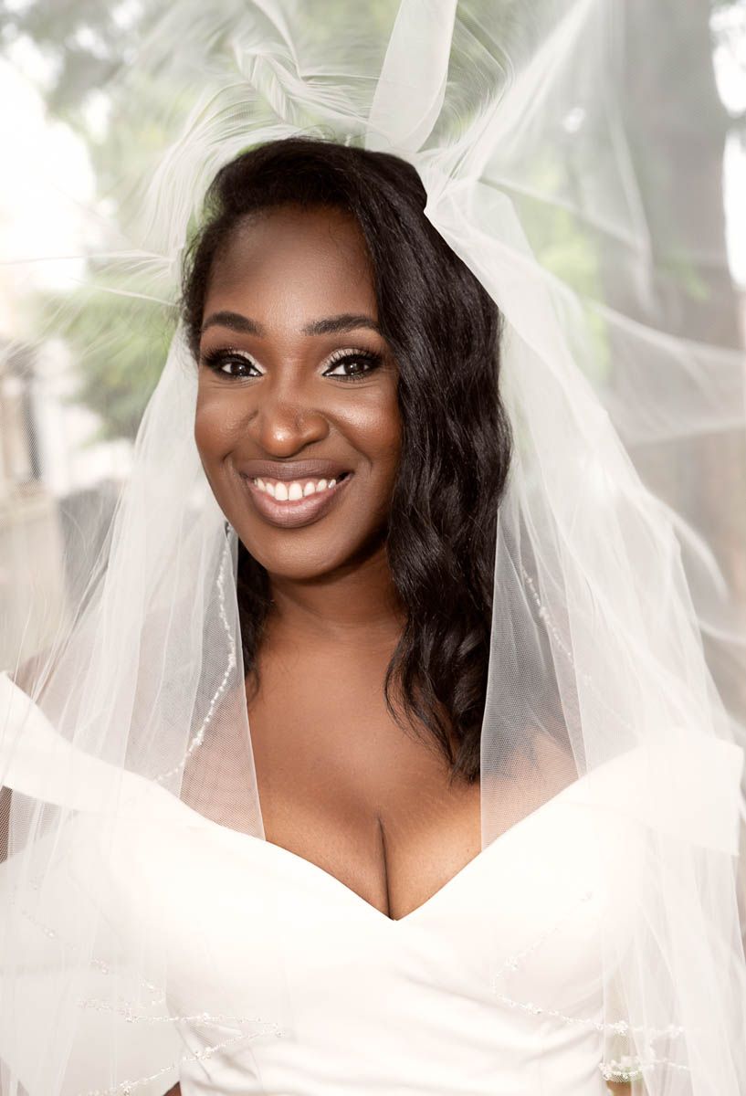 Smiling bride portrait during wedding morning with soft lighting