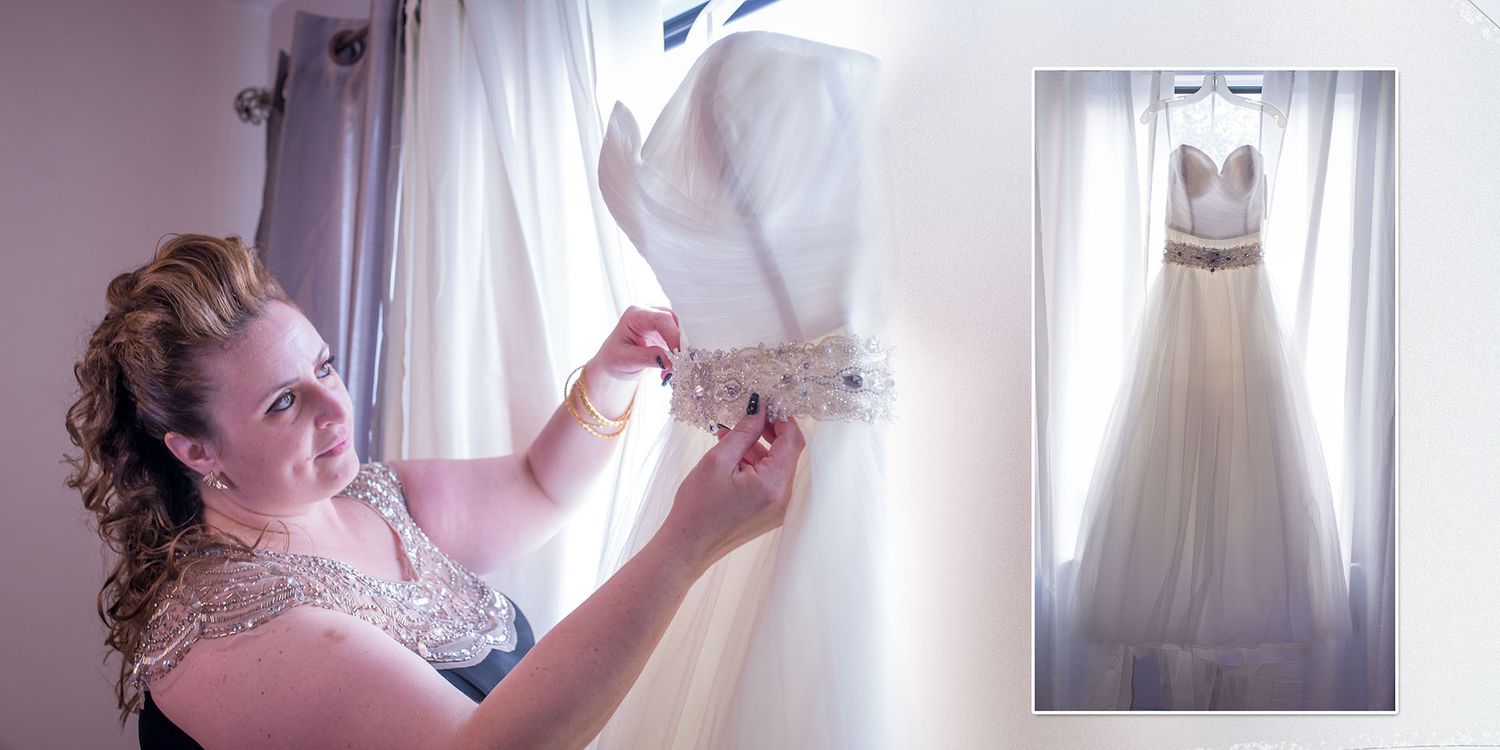 Wedding dress hanging by window during bridal preparation