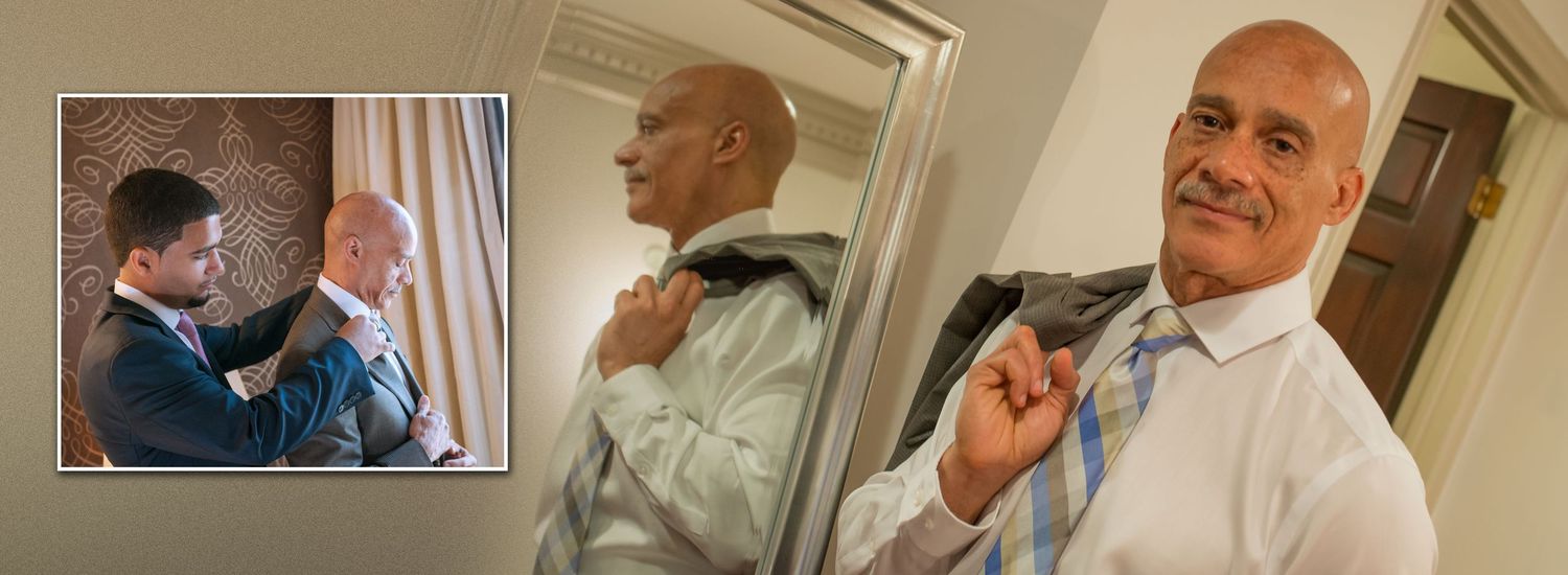 Groom preparing for wedding day adjusting jacket and details