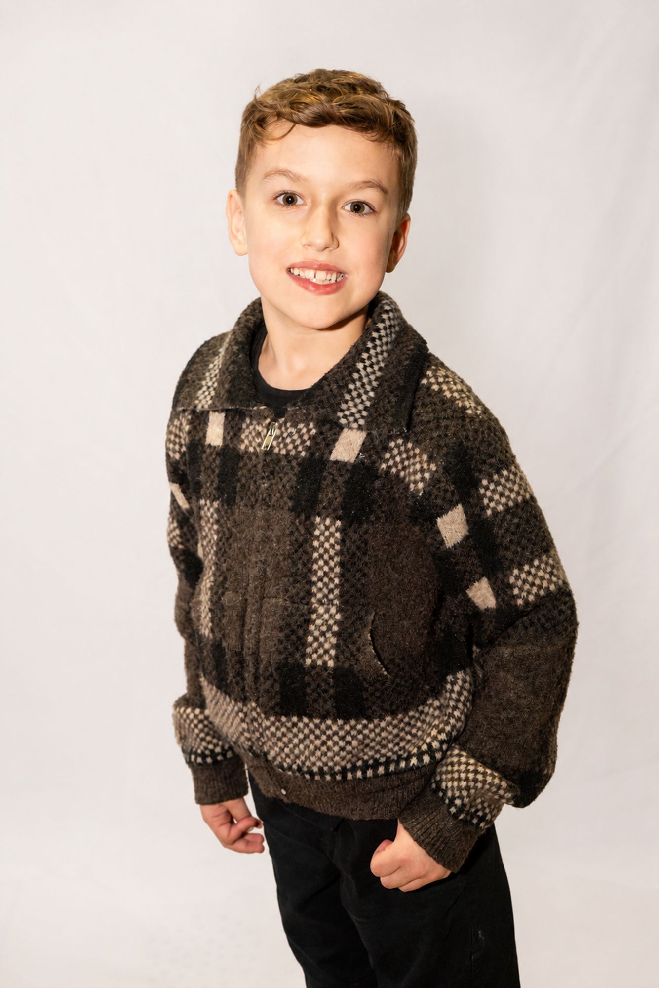 Studio portrait of a young boy photographed in formal clothing by Magic All Moment Photography.