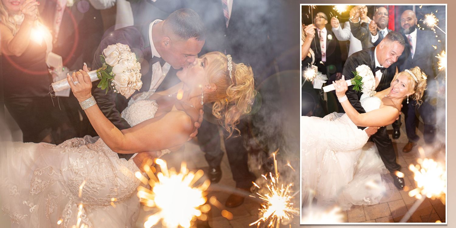 Bride and groom sharing a dip kiss surrounded by sparklers during wedding celebration