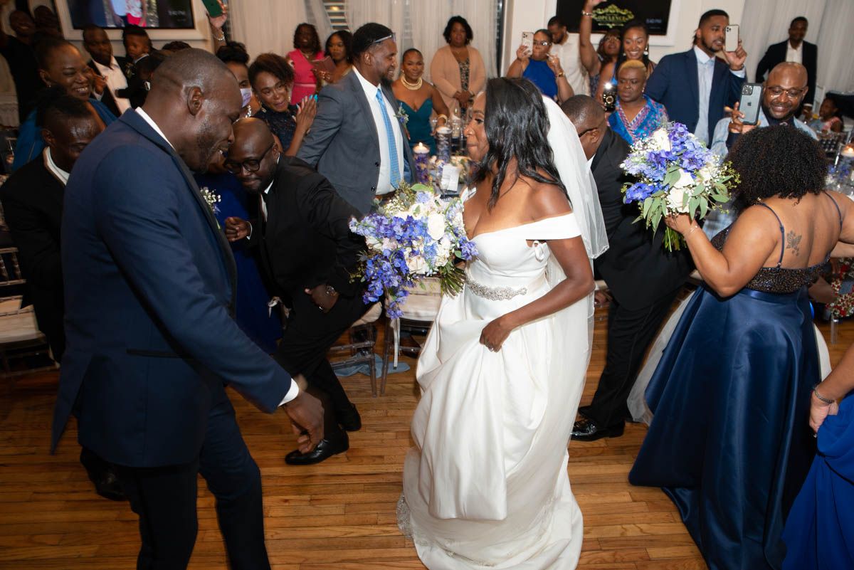 Bride dancing with guests during lively wedding reception celebration in NYC