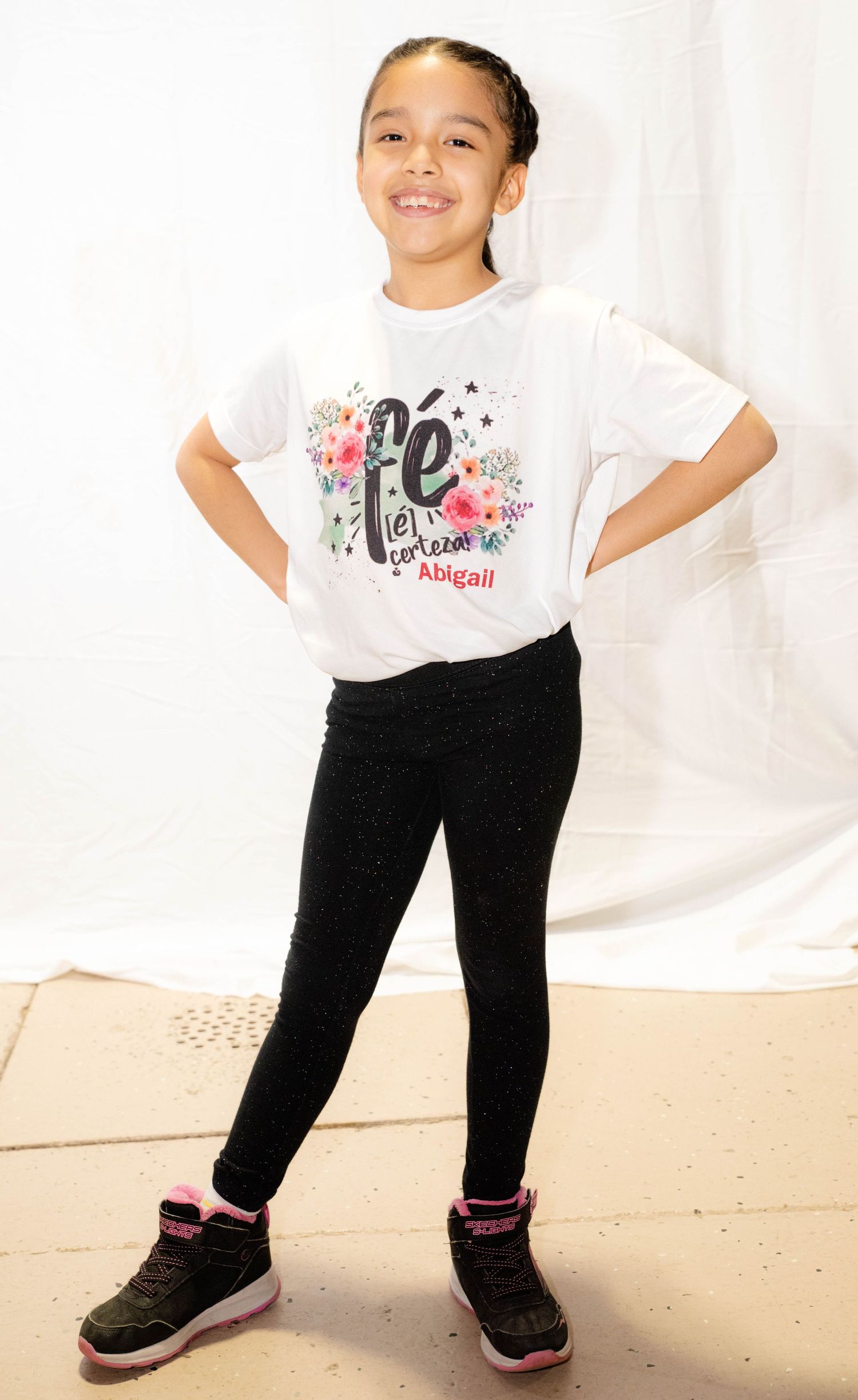 Child posing for a simple studio portrait by Magic All Moment Photography.