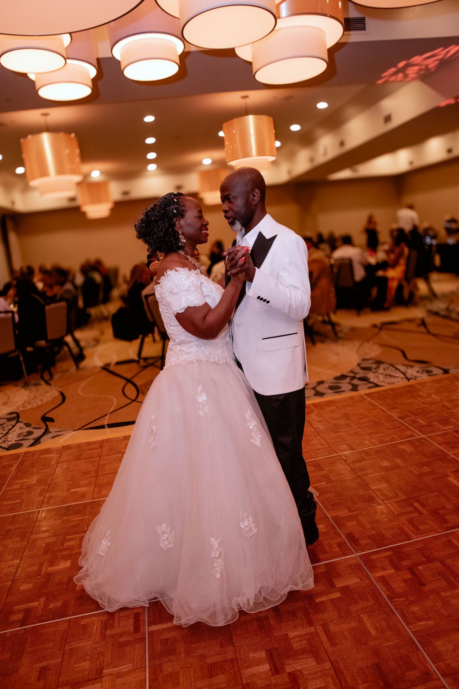 Bride and groom dancing together during their wedding reception.by Magic All Moment Photography