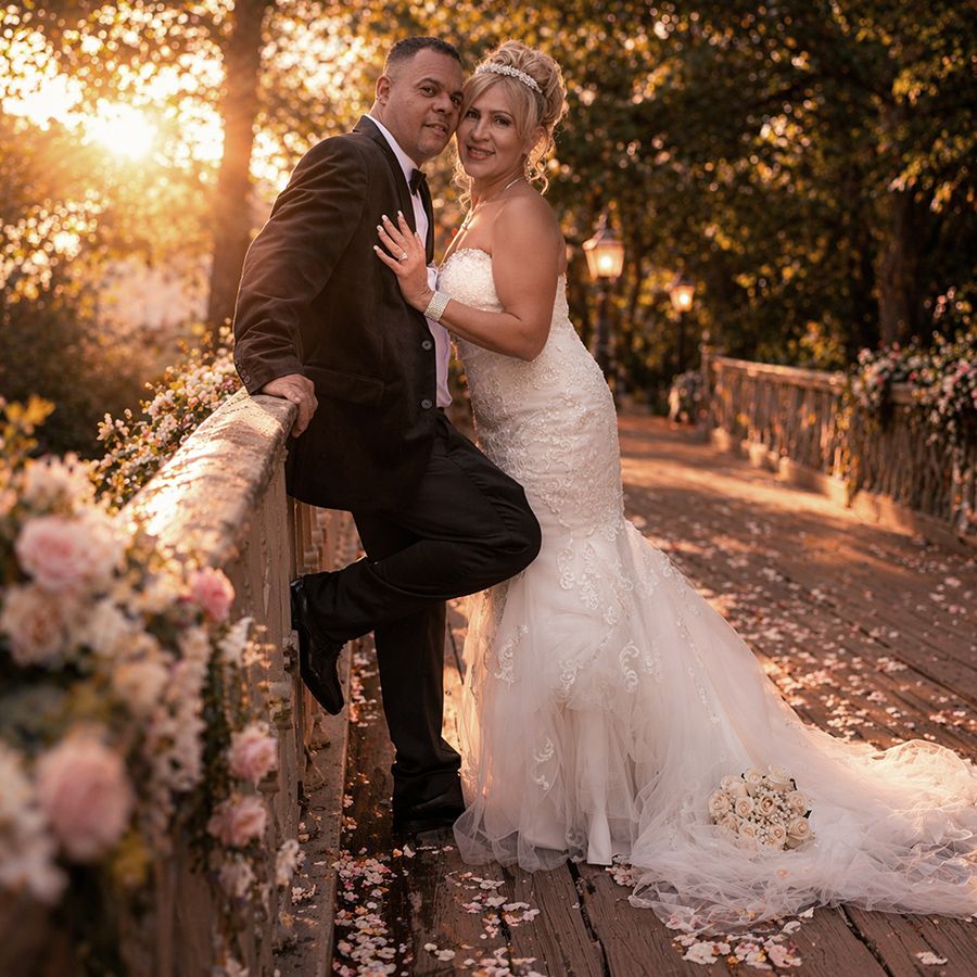Bride and groom posing together during golden hour wedding portrait session outdoors