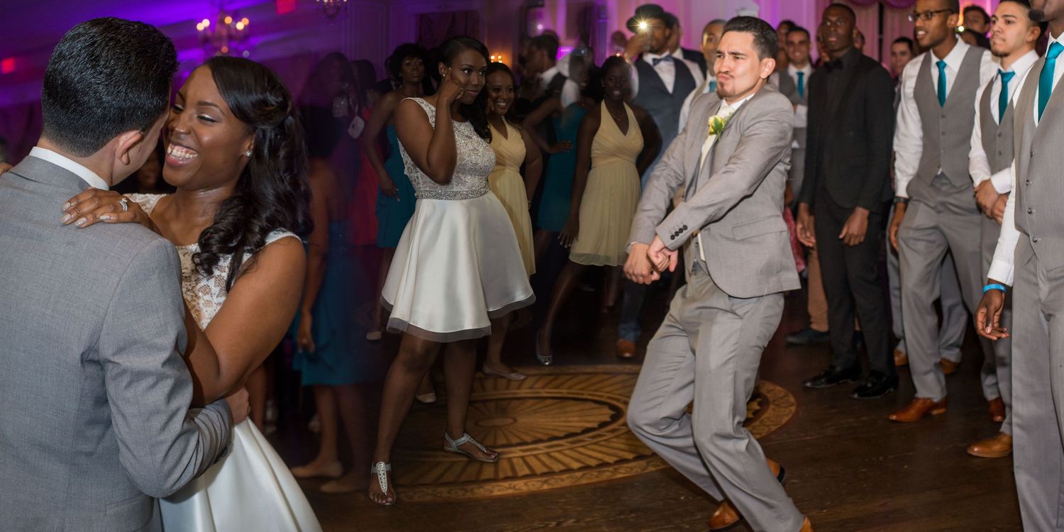 Bride and Groom dancing on a packed wedding dance floor during a lively reception celebration in NYC