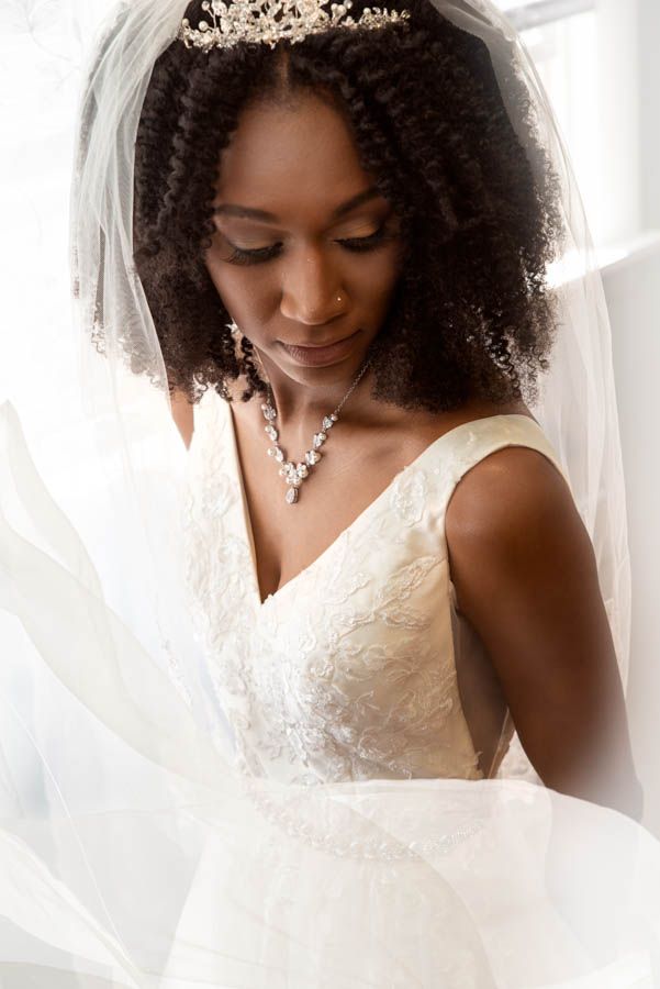 Soft natural light bridal portrait of bride during preparation