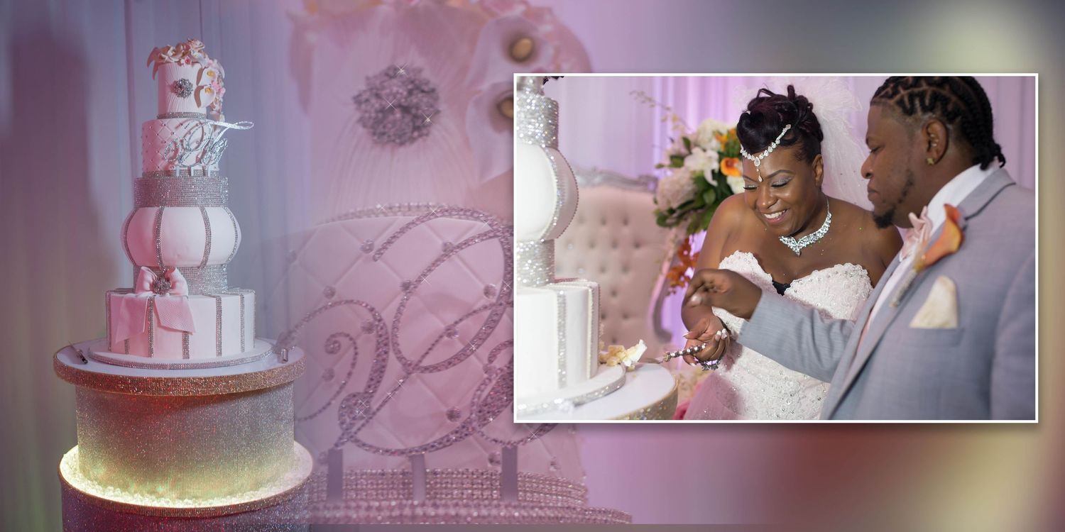 Bride and groom posing near wedding cake during reception