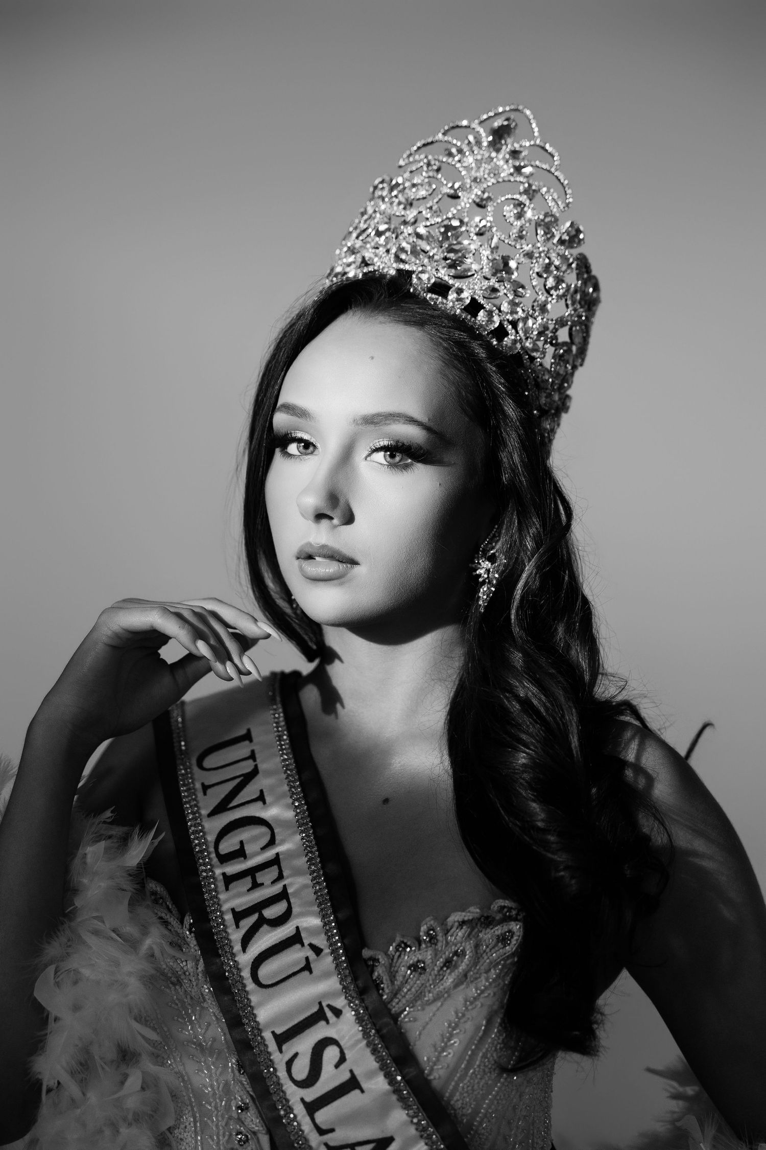 Black and white portrait of a beauty queen wearing a sparkling crown and sash reading Ungeru Islands.