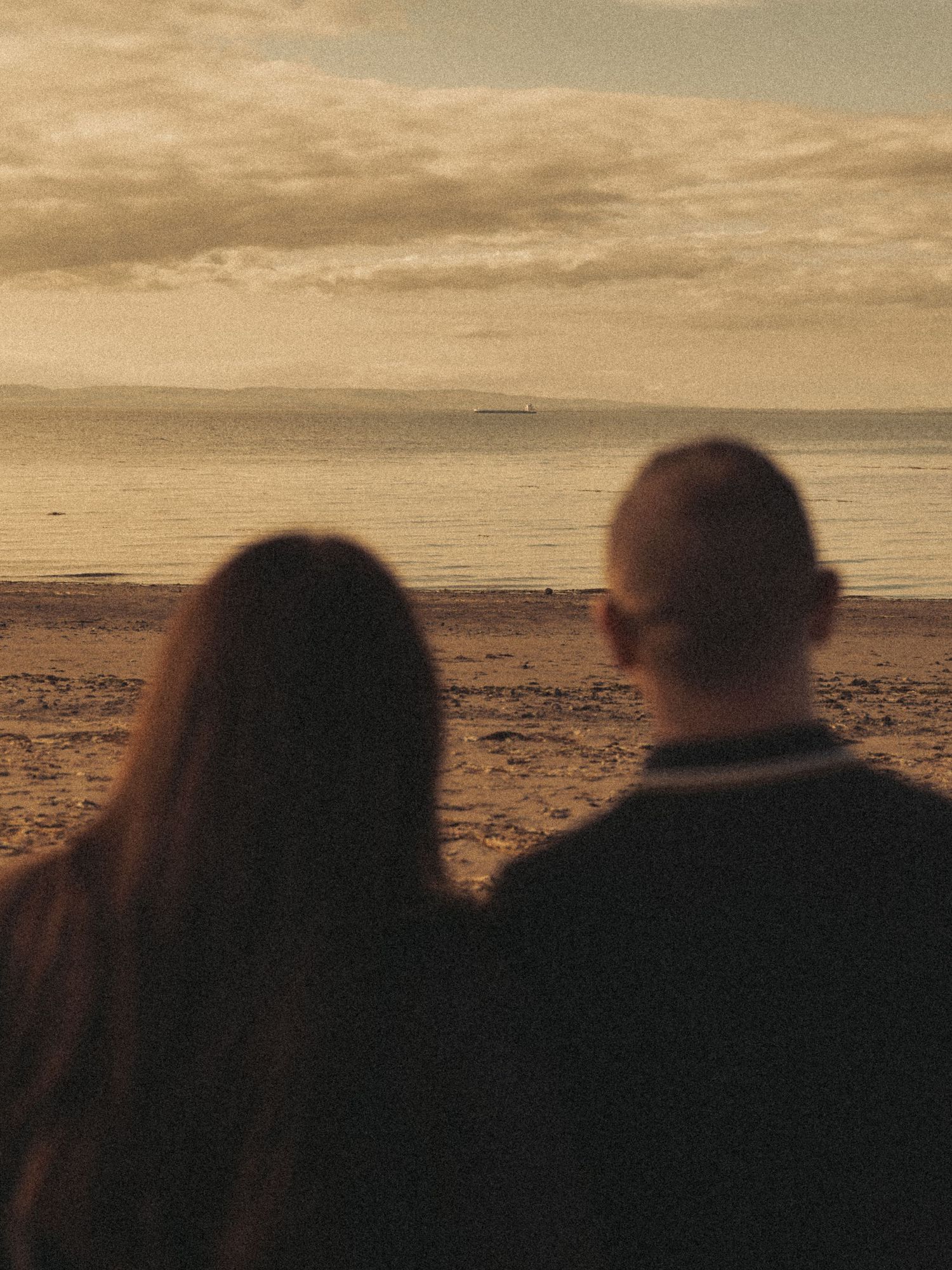 Beach engagement shoot, alternative couple. Doc martens and tattoos.