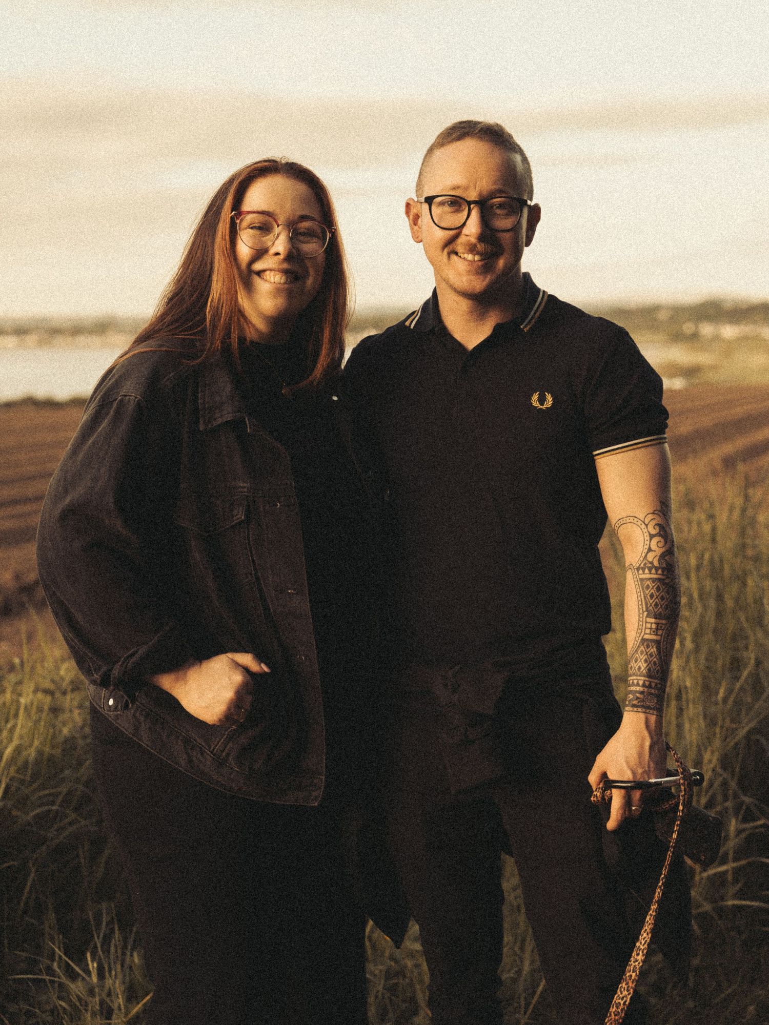 Beach engagement shoot, alternative couple. Doc martens and tattoos.