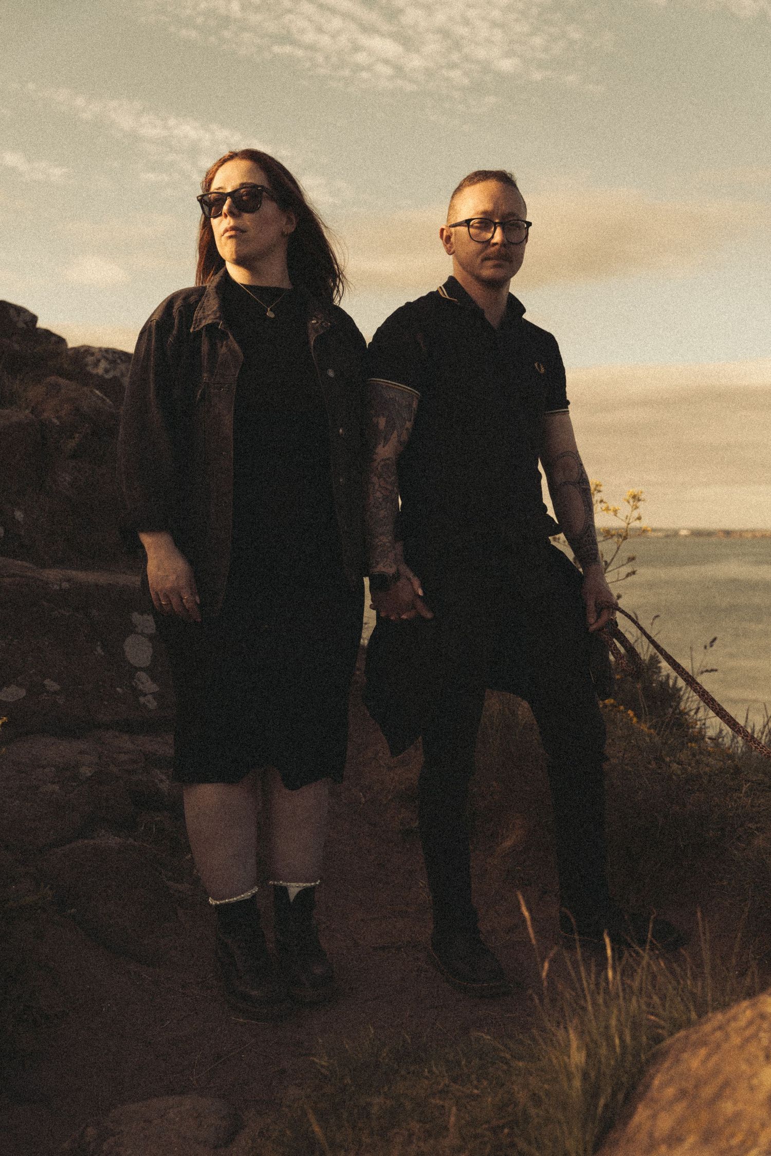 Beach engagement shoot, alternative couple. Doc martens and tattoos.
