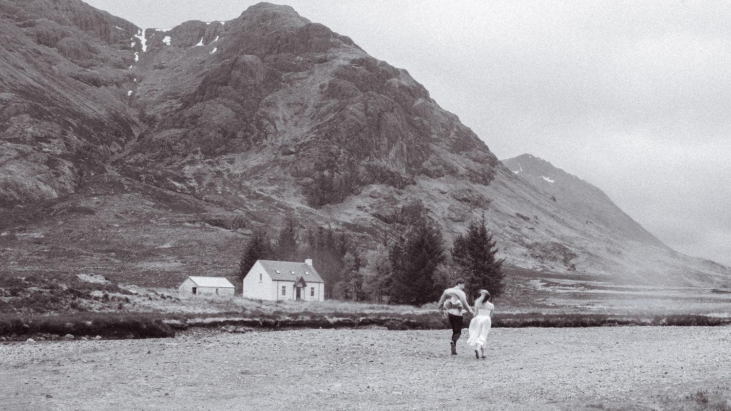 Black and white, editorial, cinematic engagement shoot. Running couple to Bothy. Engagement shoot, couples photographer. Highland elopement.