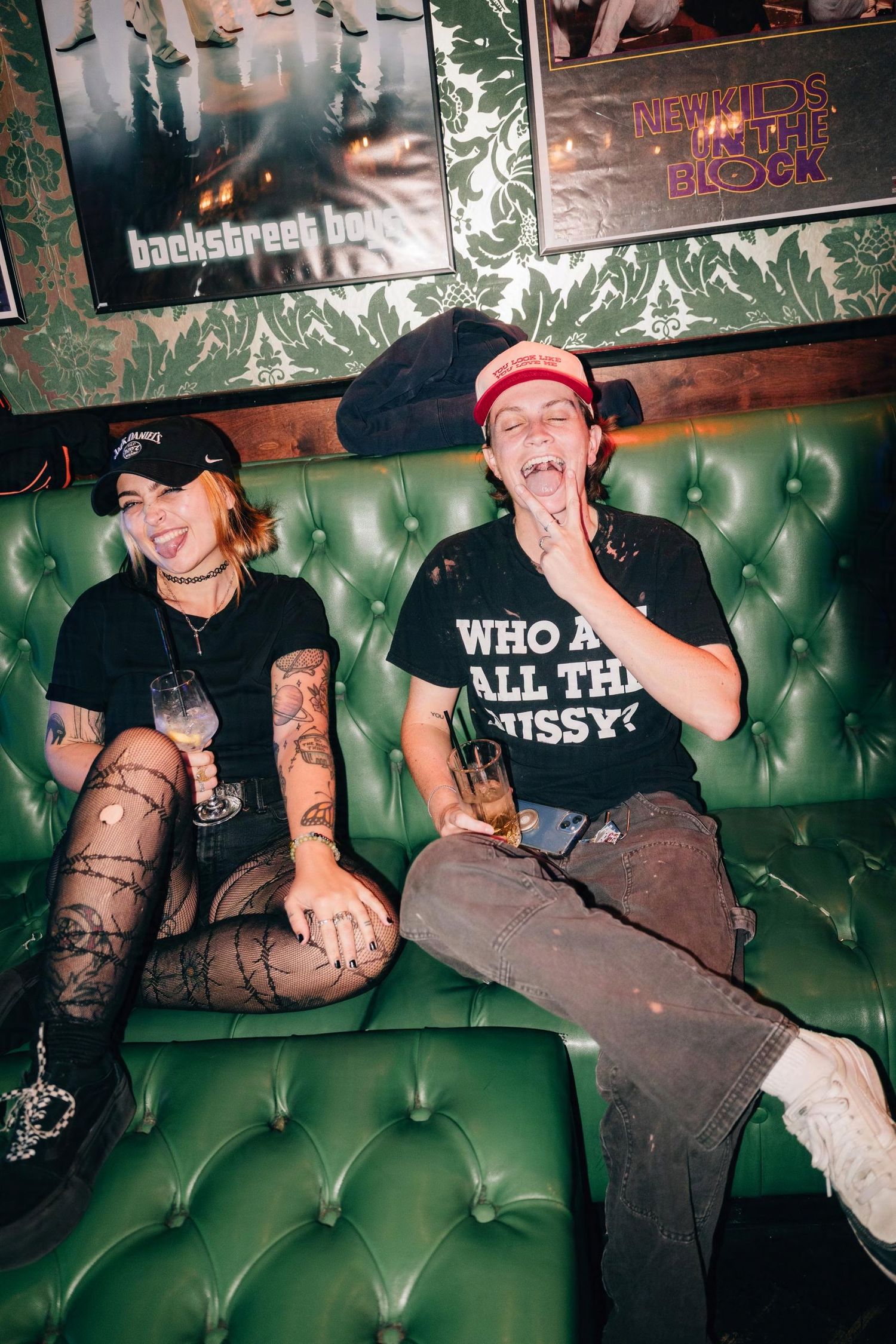 A lesbian couple poses for a party photo. (Remix Room)

© snapnon 2026