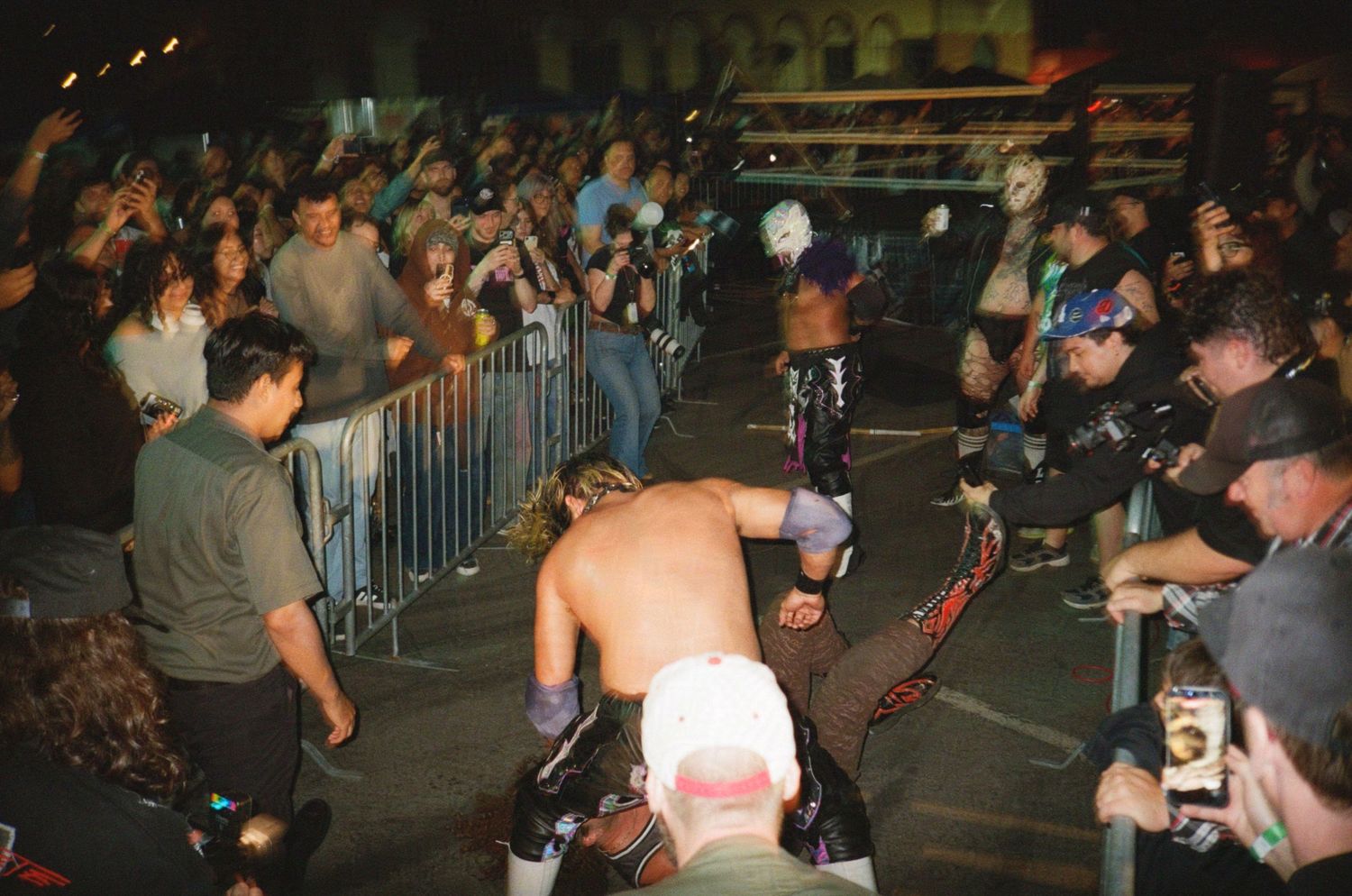 Some wrestlers duke it out in front of an audience. (circle6 at Titmouse Studios)

35mm film photo
© snapnon 2026