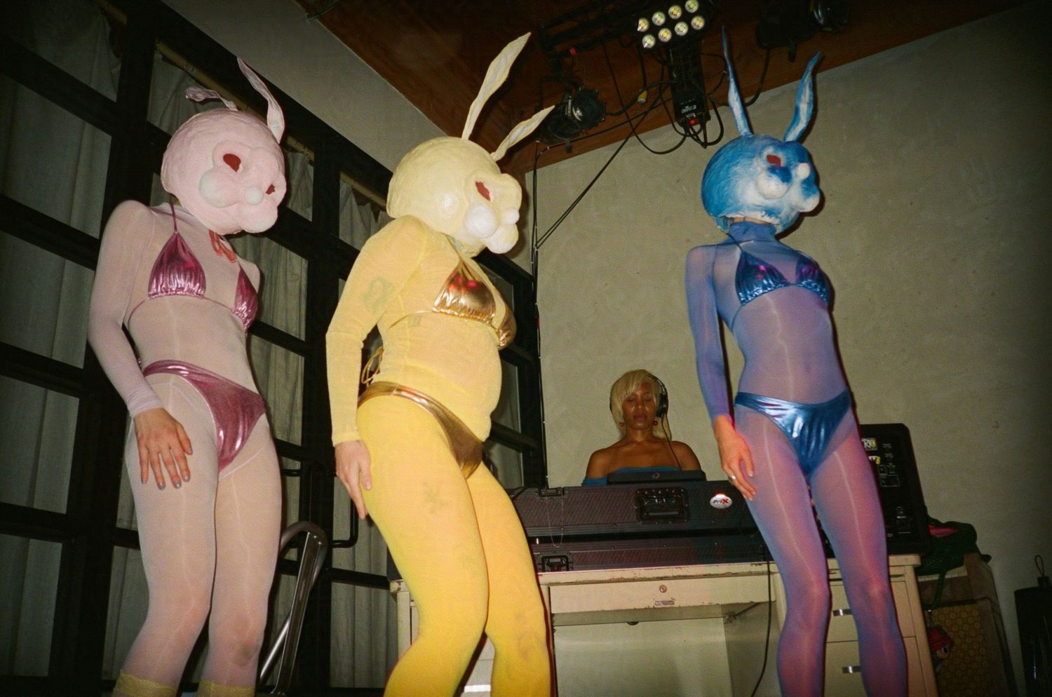 Three dancers dressed as bunnies for Easter with a DJ on stage. (99warehouse)

35mm film photo
© snapnon 2026