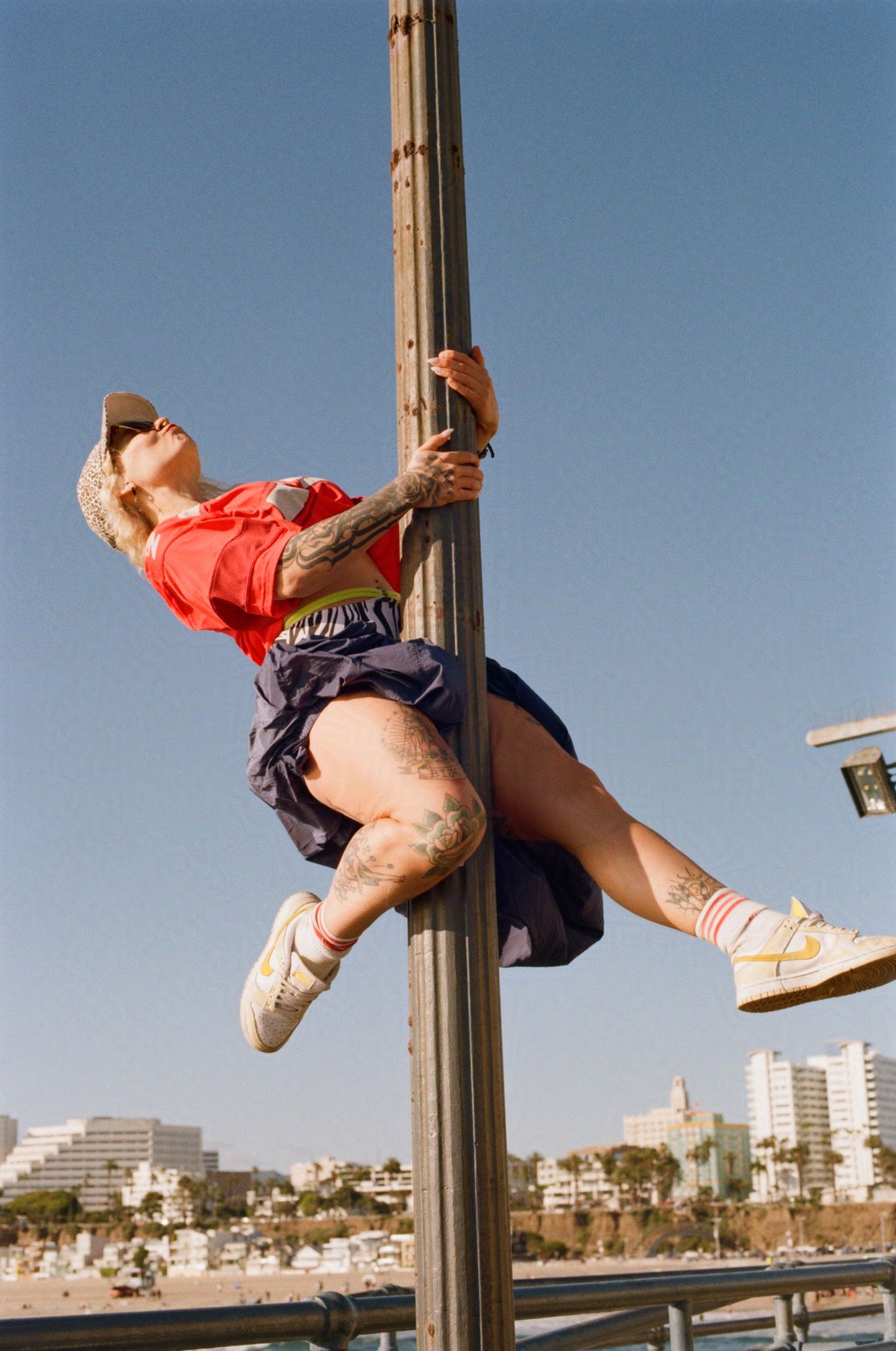 Parisian burlesque performer Djerry Can dances on a lightpole. (Santa Monica Pier)

35mm film photo
© snapnon 2026