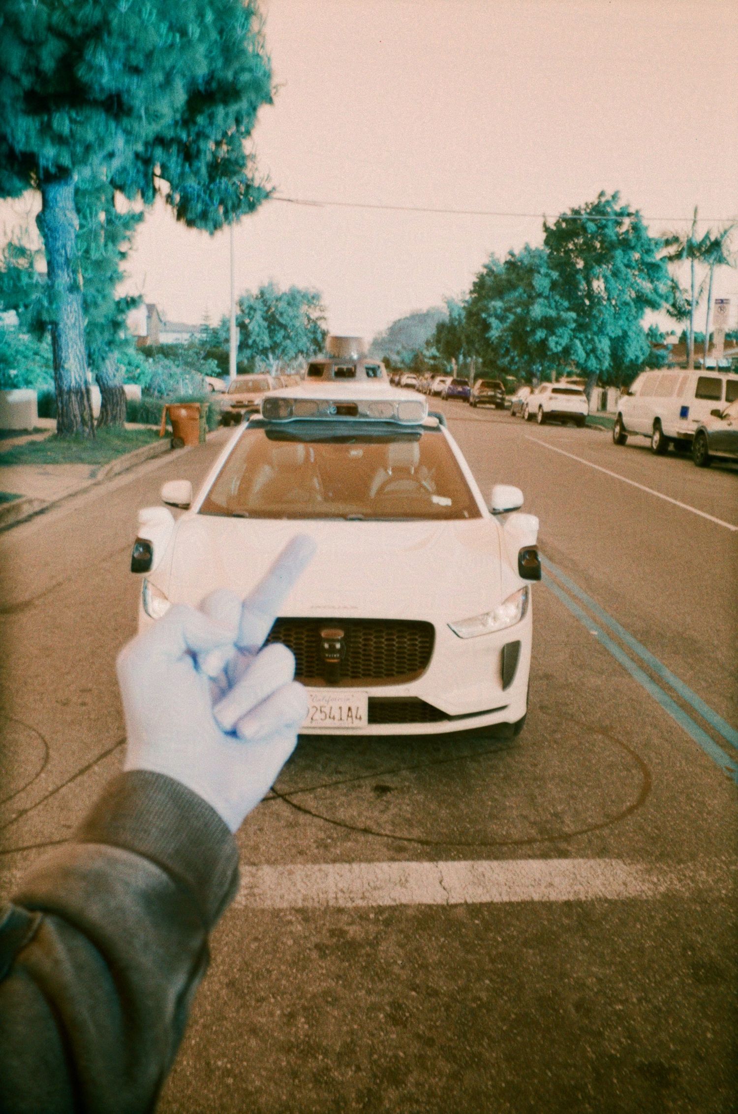 Flipping off a Waymo for taking jobs away from drivers on LomoChrome Turquoise film.

35mm film photo
© snapnon 2026