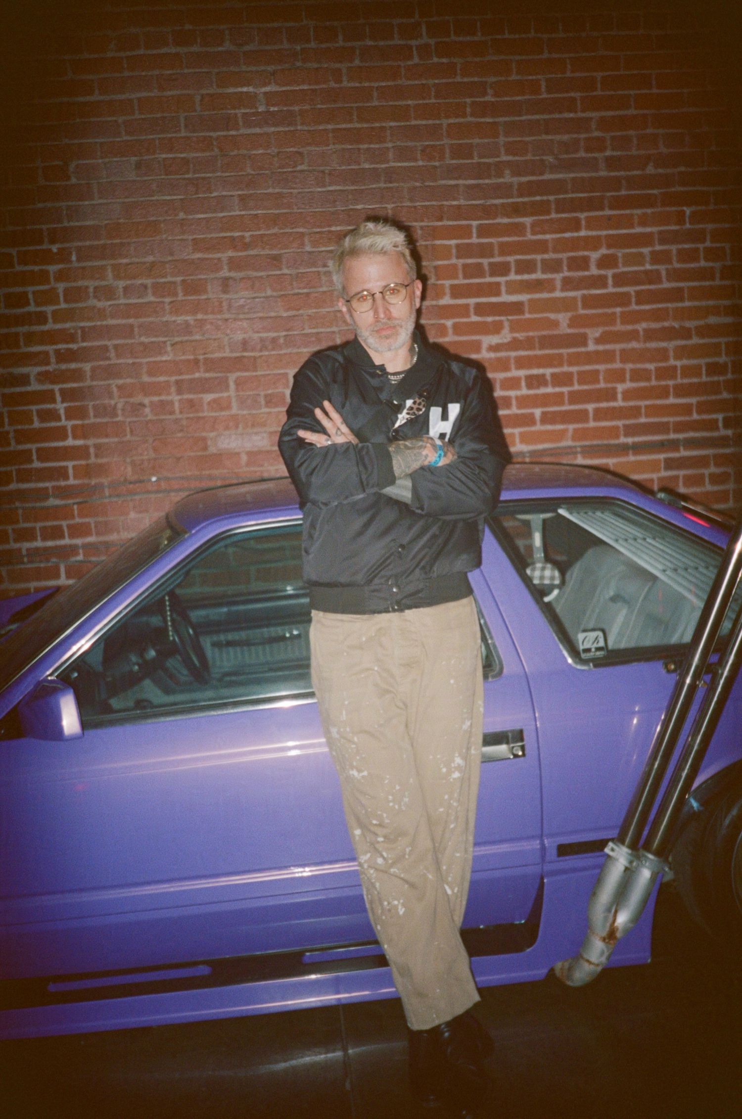The Glitch Mob's Josh Mayer poses in front of a purple car. (Machine Aesthetic at 8th and Santa Fe)

35mm film photo
© snapnon 2026