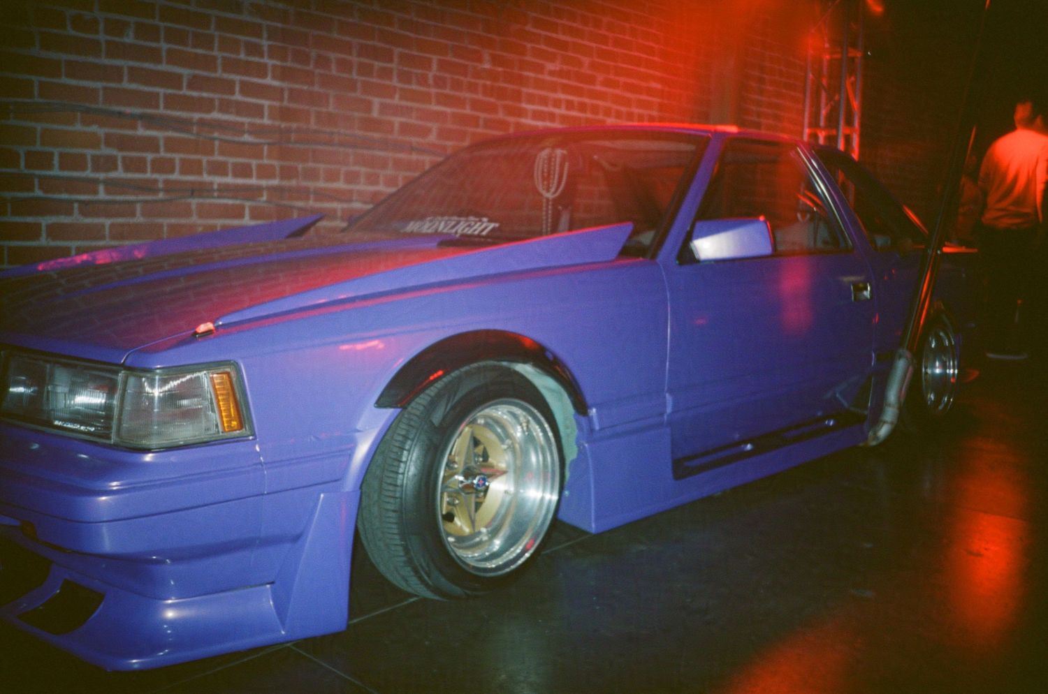 A modded purple car with dramatic lighting. (Machine Aesthetic at 8th and Santa Fe)

35mm film photo
© snapnon 2026