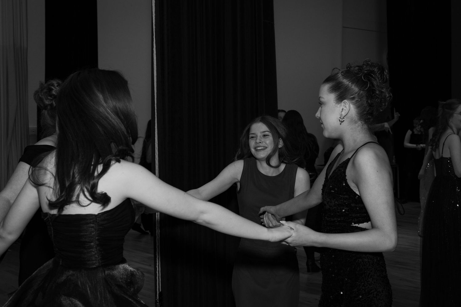 Group of friends dancing at a winter ball party event in the hall of a school in black and white.

Edinburgh Event Photographer.