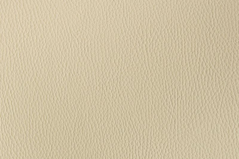 A textured beige or cream colored background with a subtle woven pattern and soft lighting.