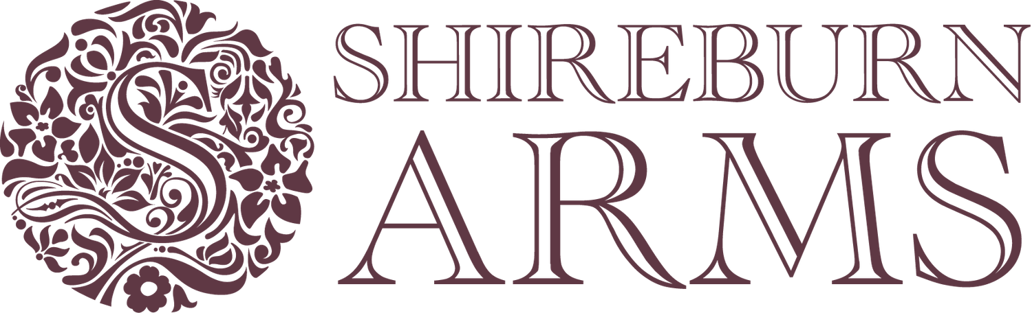 Shireburn Arms hotel and restaurant logo featuring an ornate floral monogram in elegant burgundy typography.